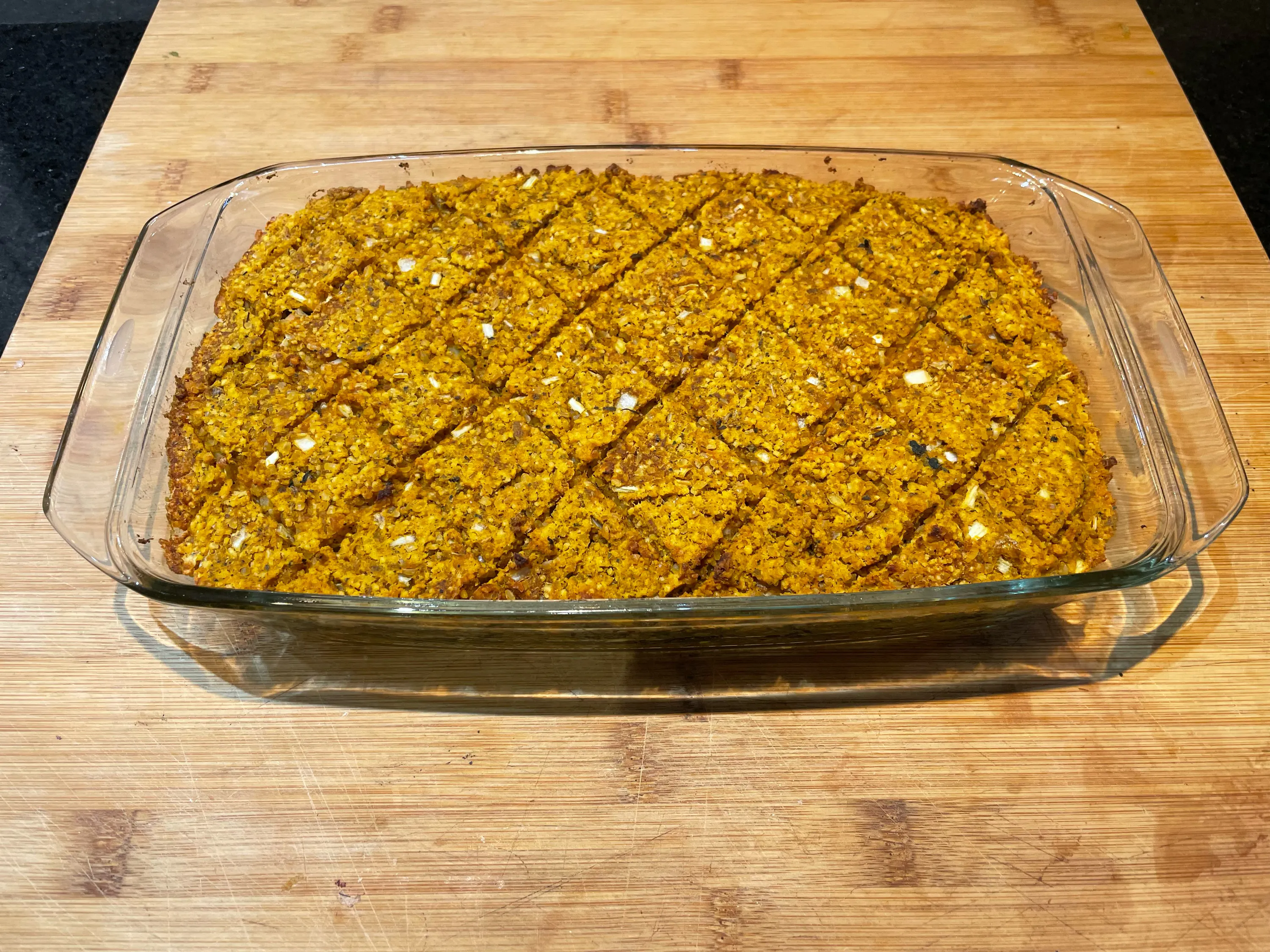 Auf einem Holztisch steht ein Glasgefäß mit einem gelb-weißen Essen