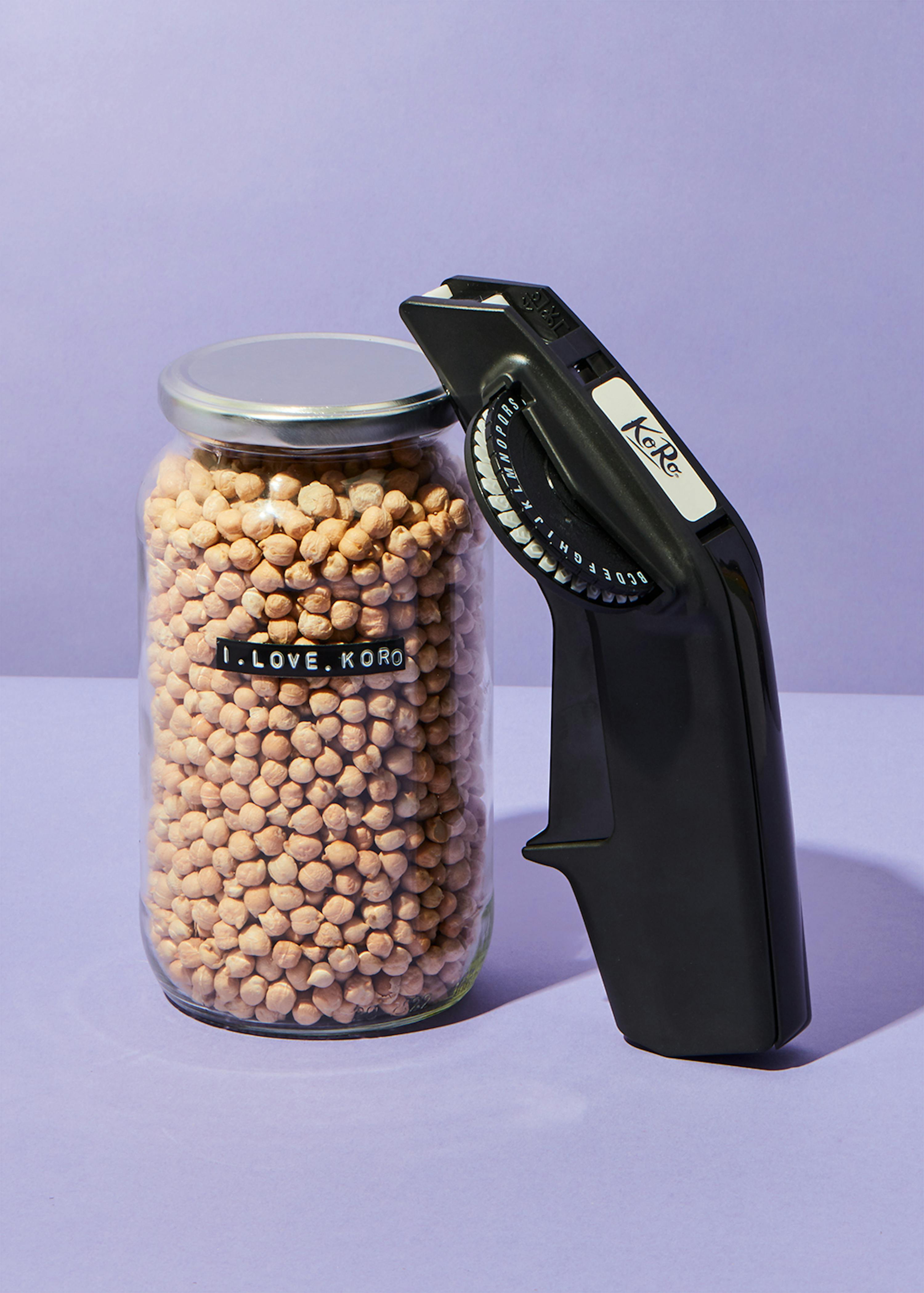 a jar of chickpeas next to a labeler that says koro