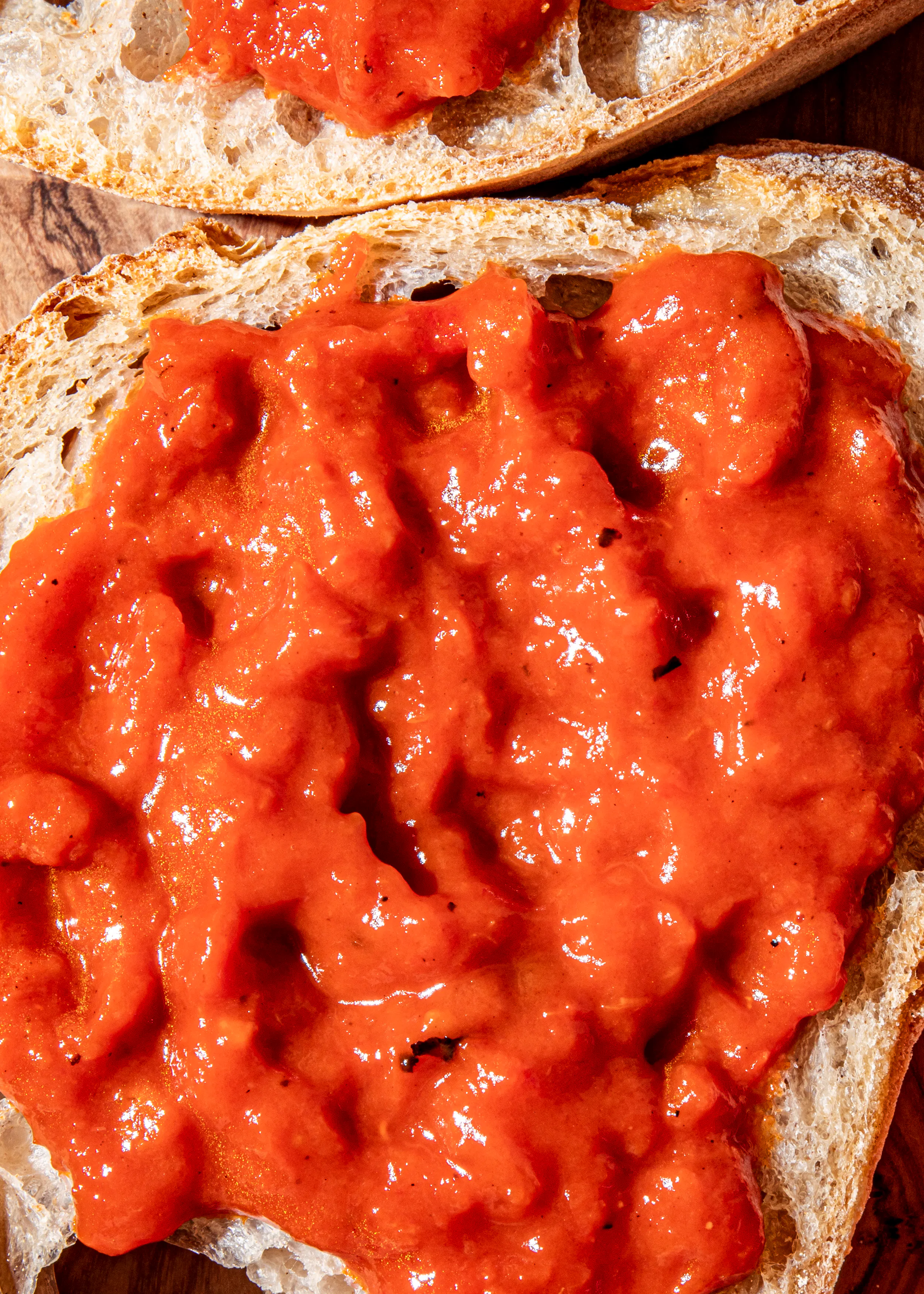 a close up of a piece of bread with tomato sauce on it