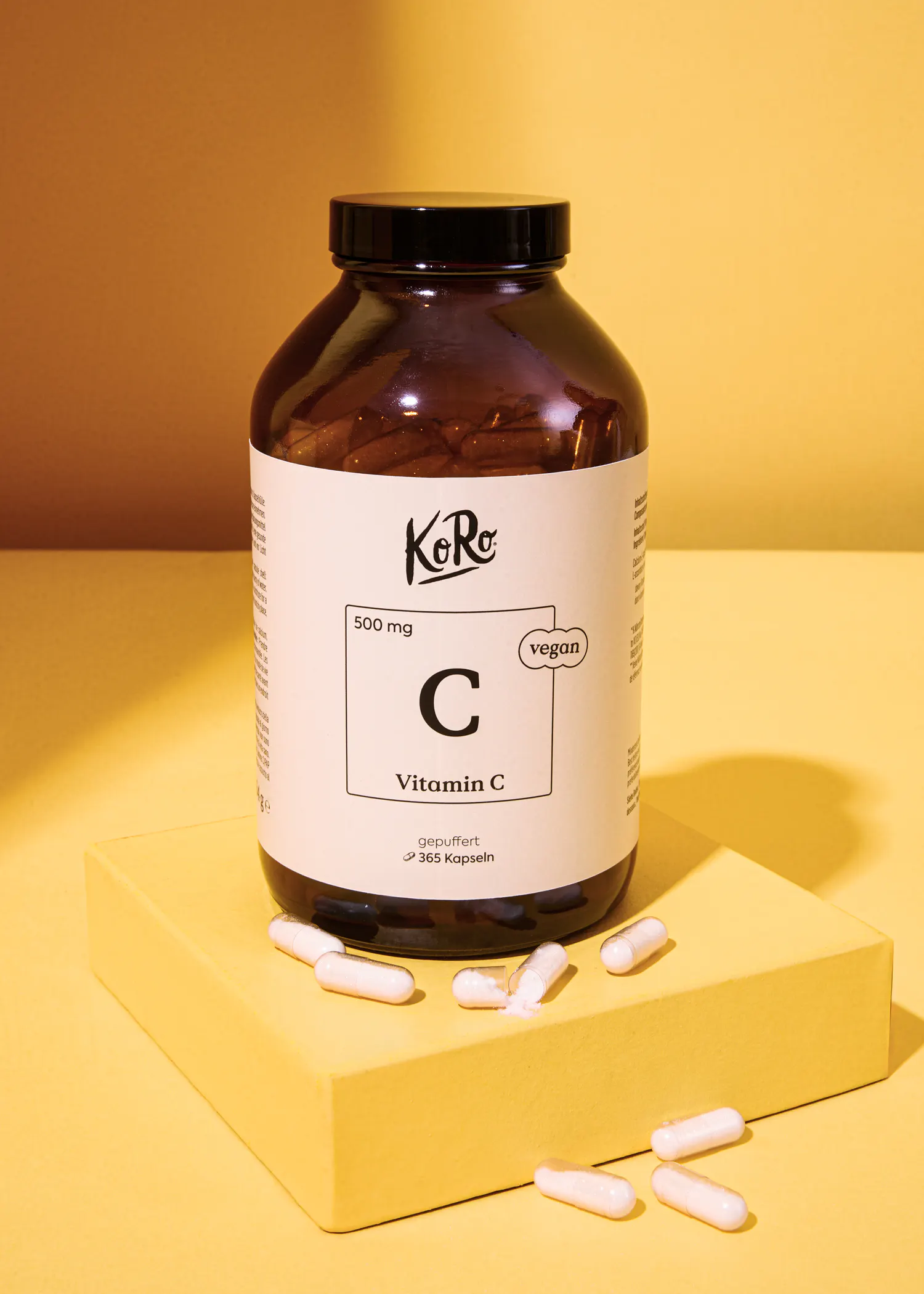 a bottle of kore vitamin c is on a yellow surface