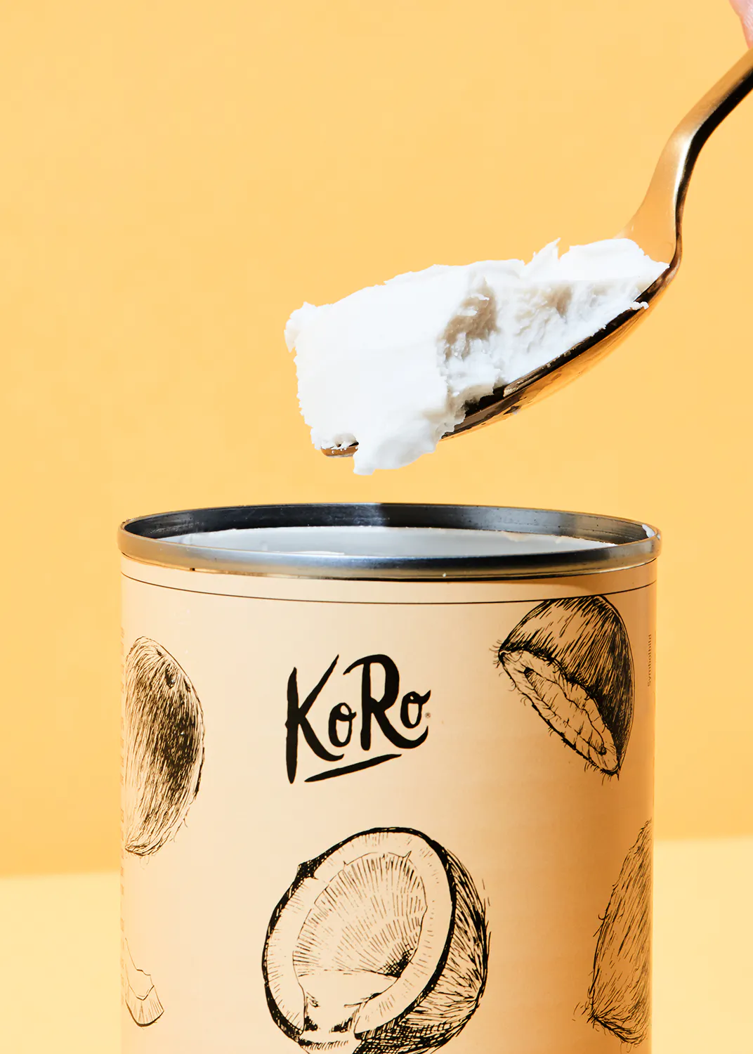 une cuillère sort d' une boîte de crème de coco
