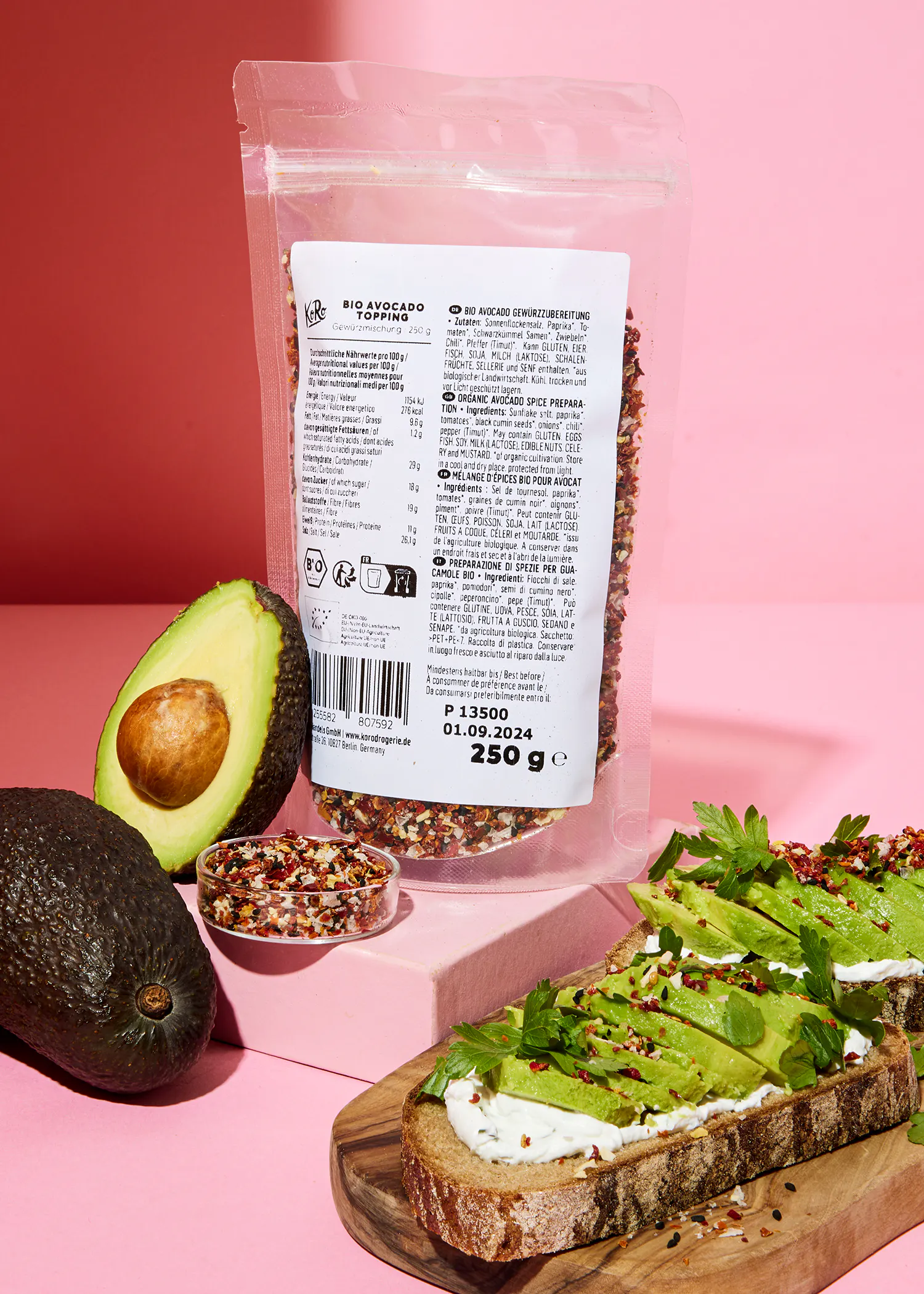 a bag of avocado seeds sits next to a sliced avocado