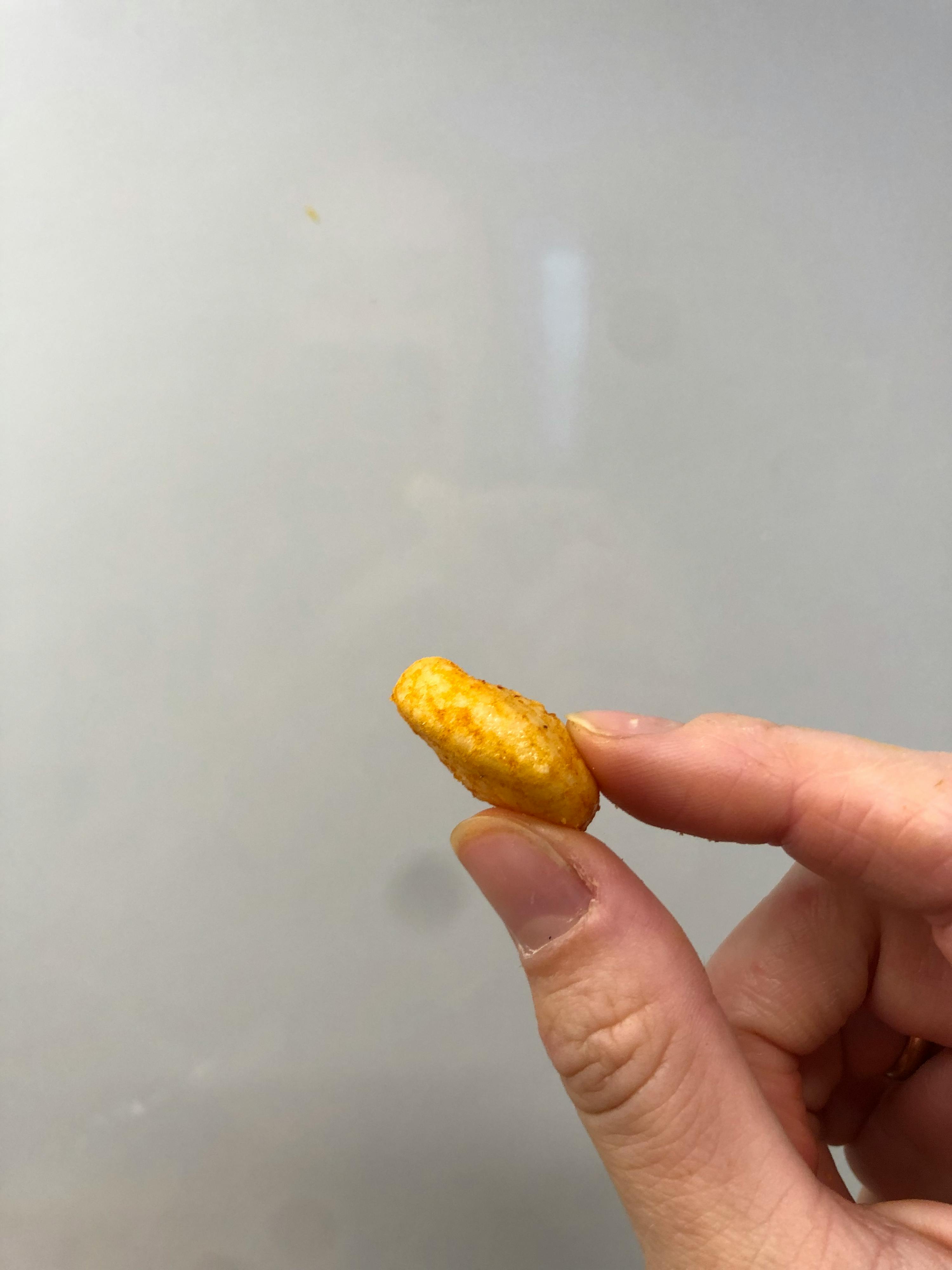 a person is holding a small piece of food in their hand