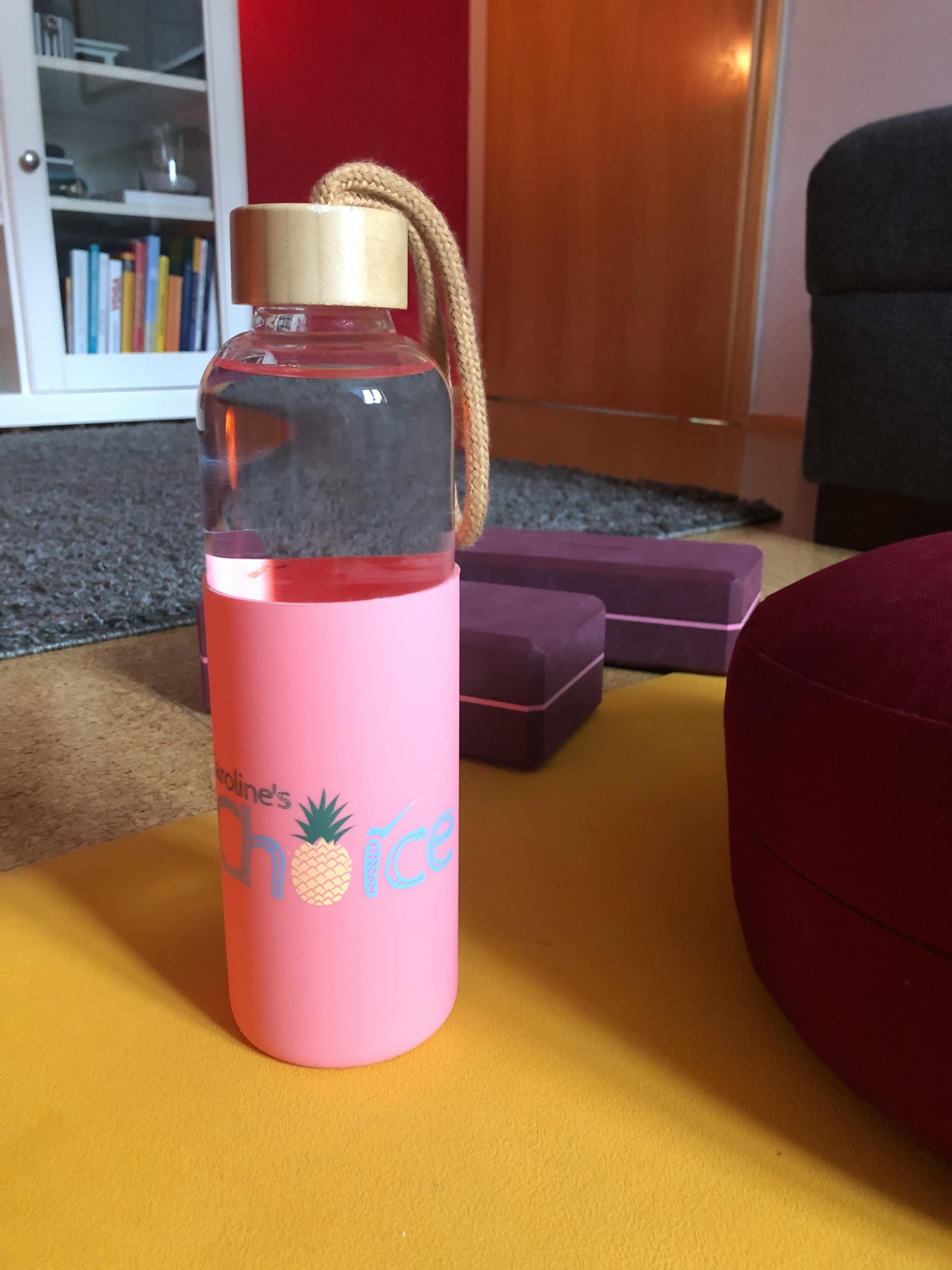 a pink water bottle with a pineapple on it