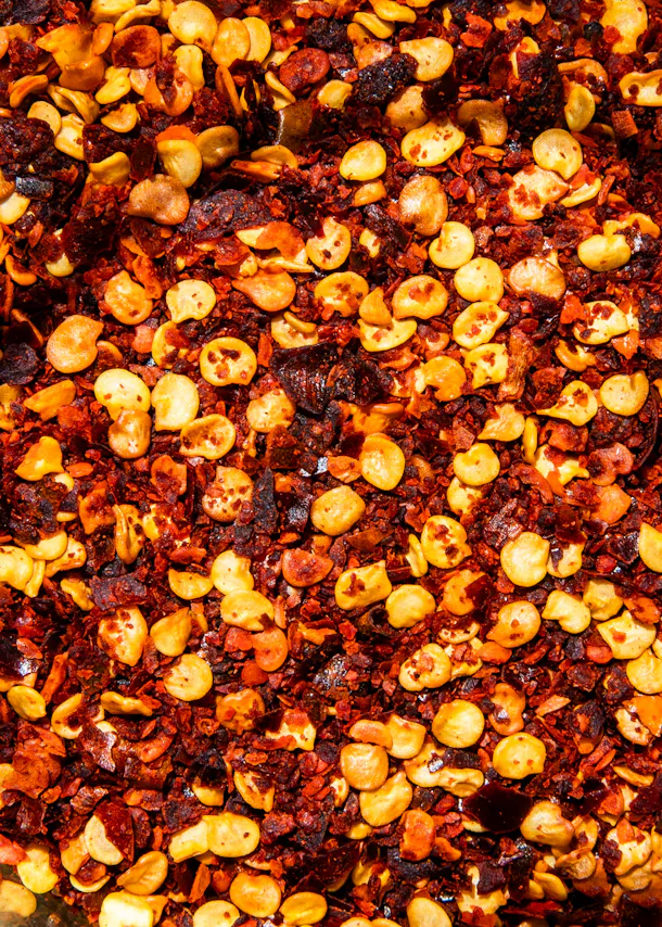 a close up of a pile of red and yellow spices