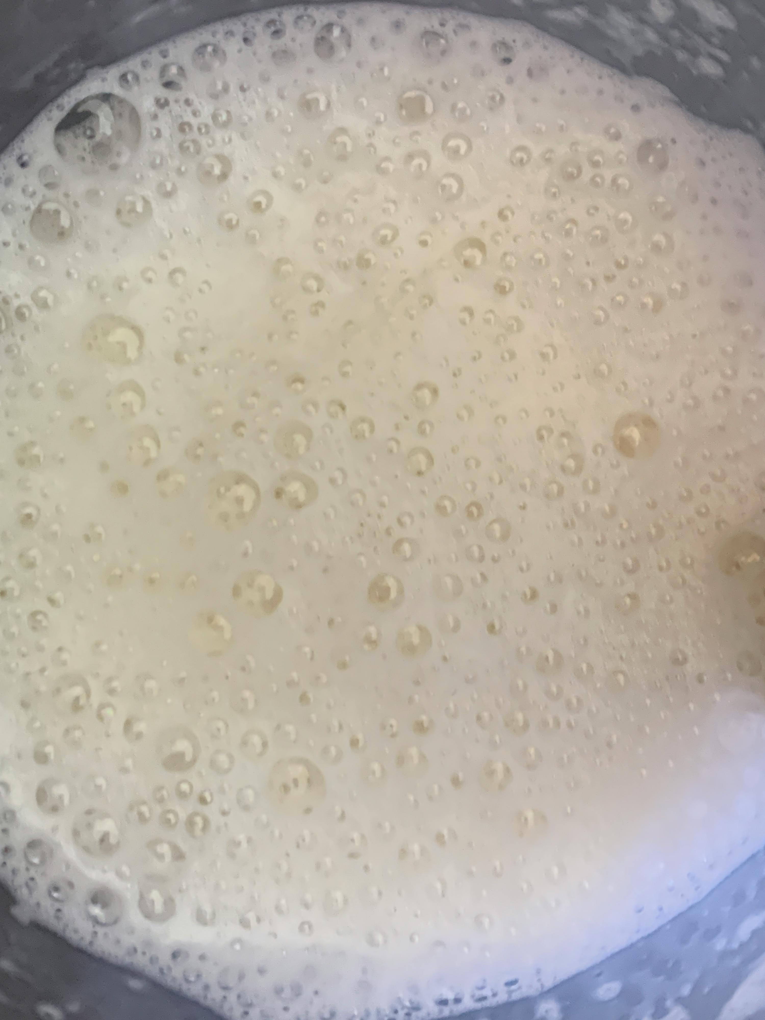 a close up of a white liquid with bubbles