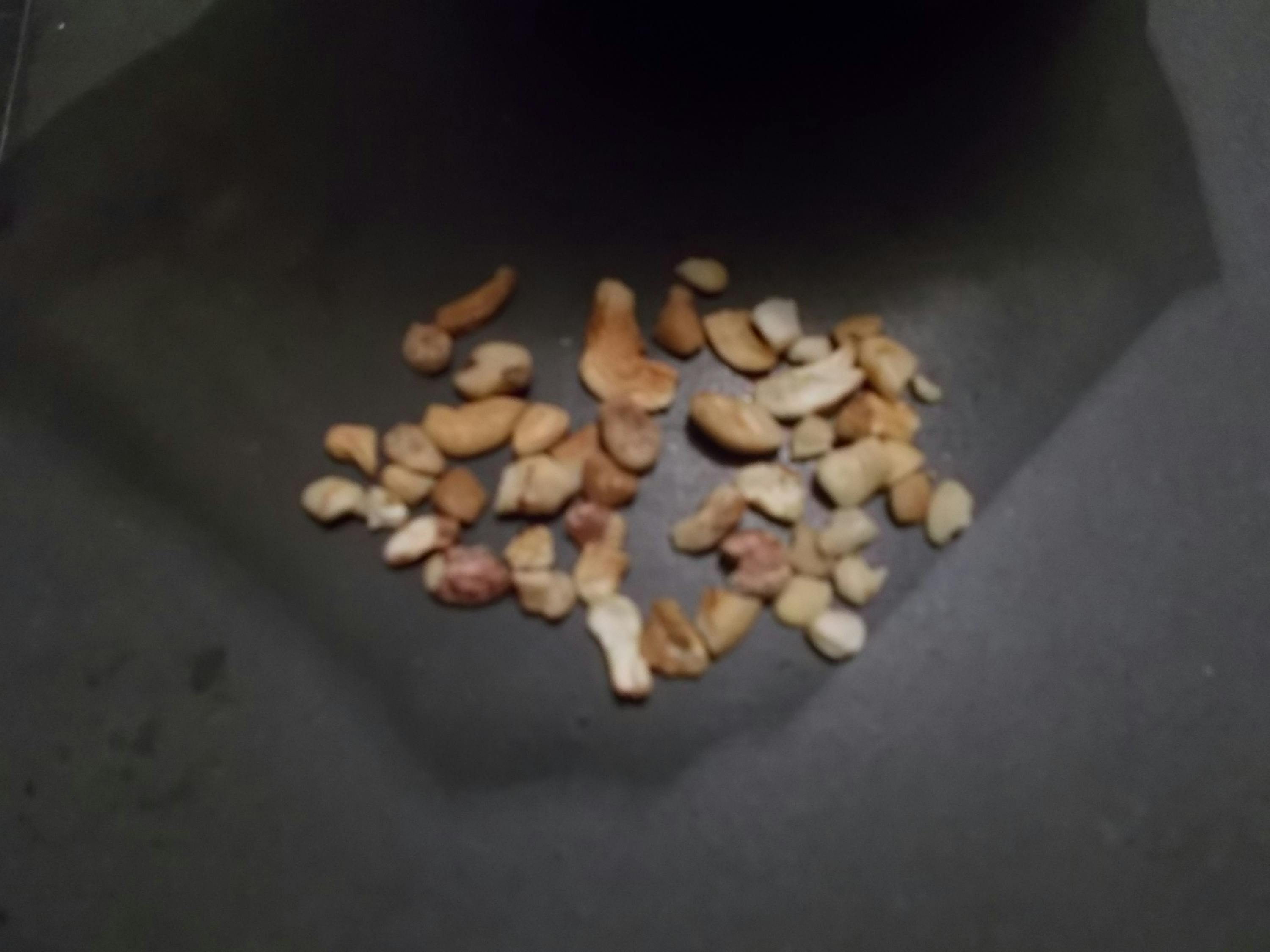 a pile of nuts is sitting on a black surface