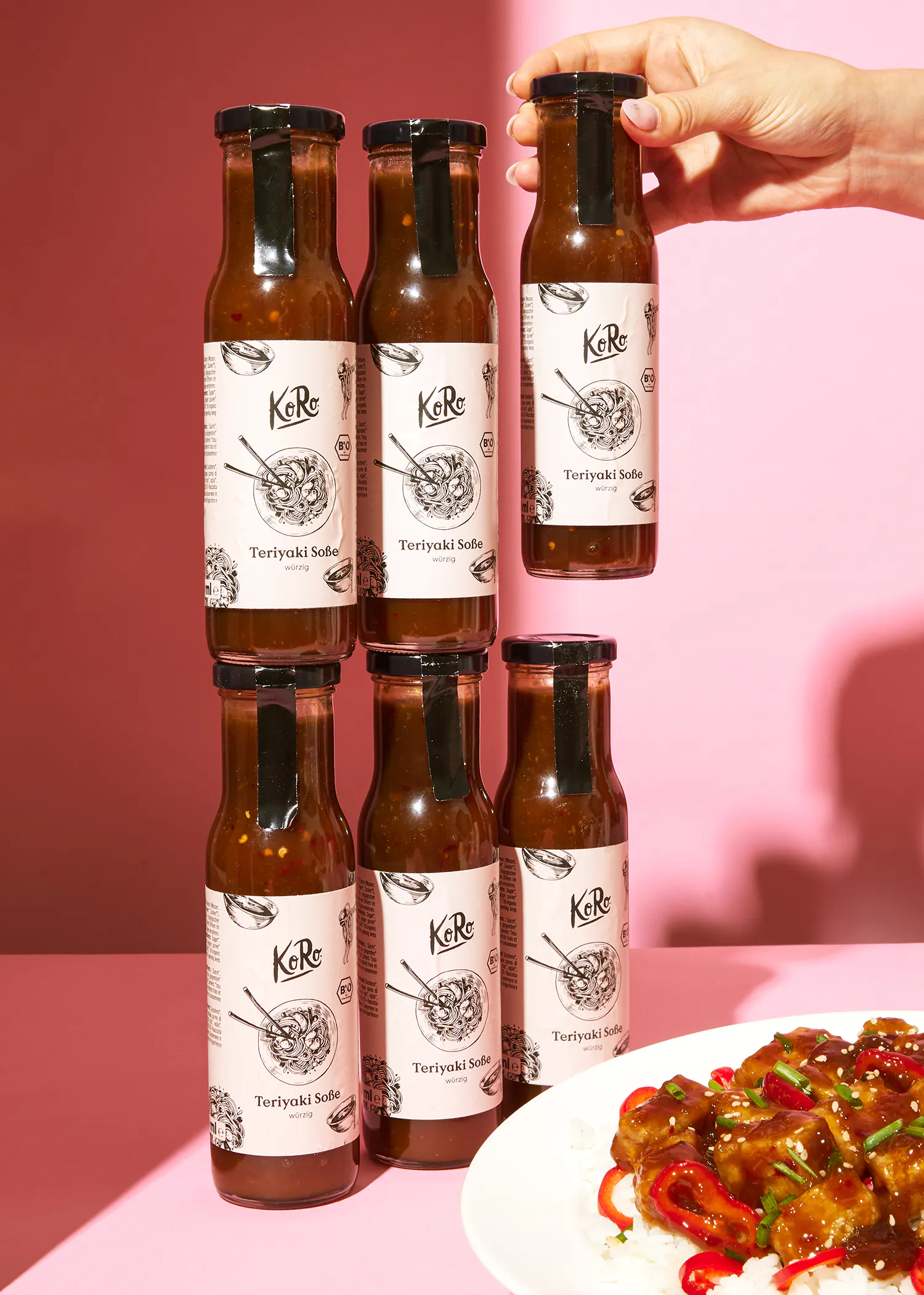 six bottles of teriyaki sauce are stacked on top of each other