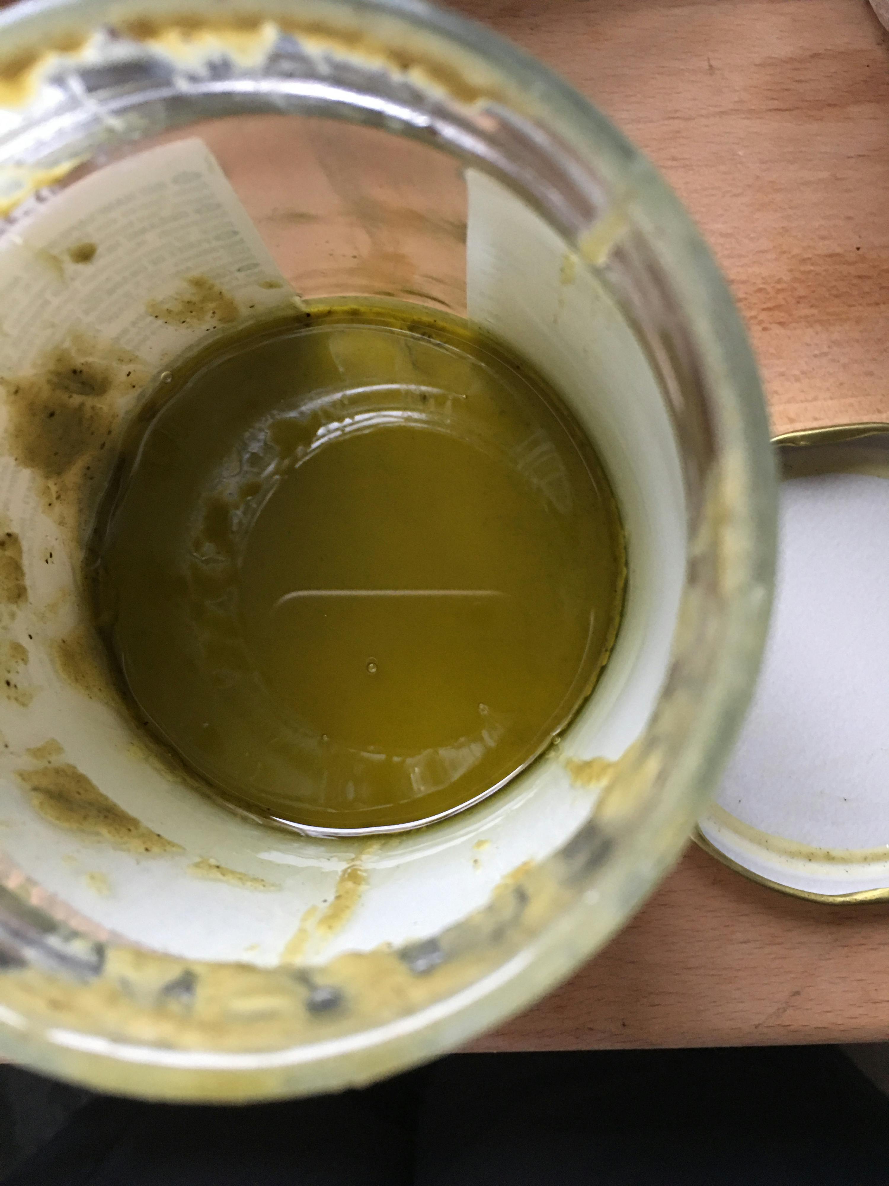 the inside of a jar with a yellow liquid in it
