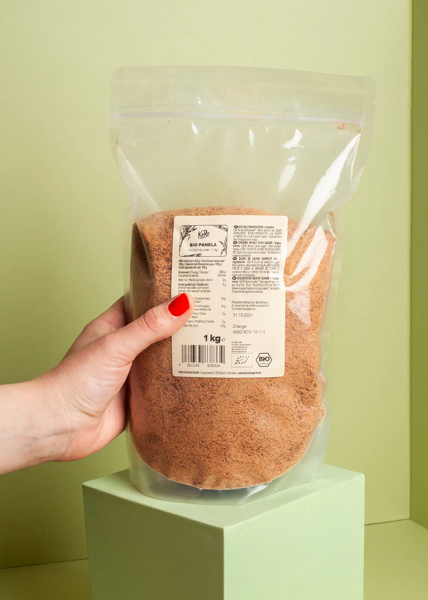 a person is holding a bag of bio popcorn