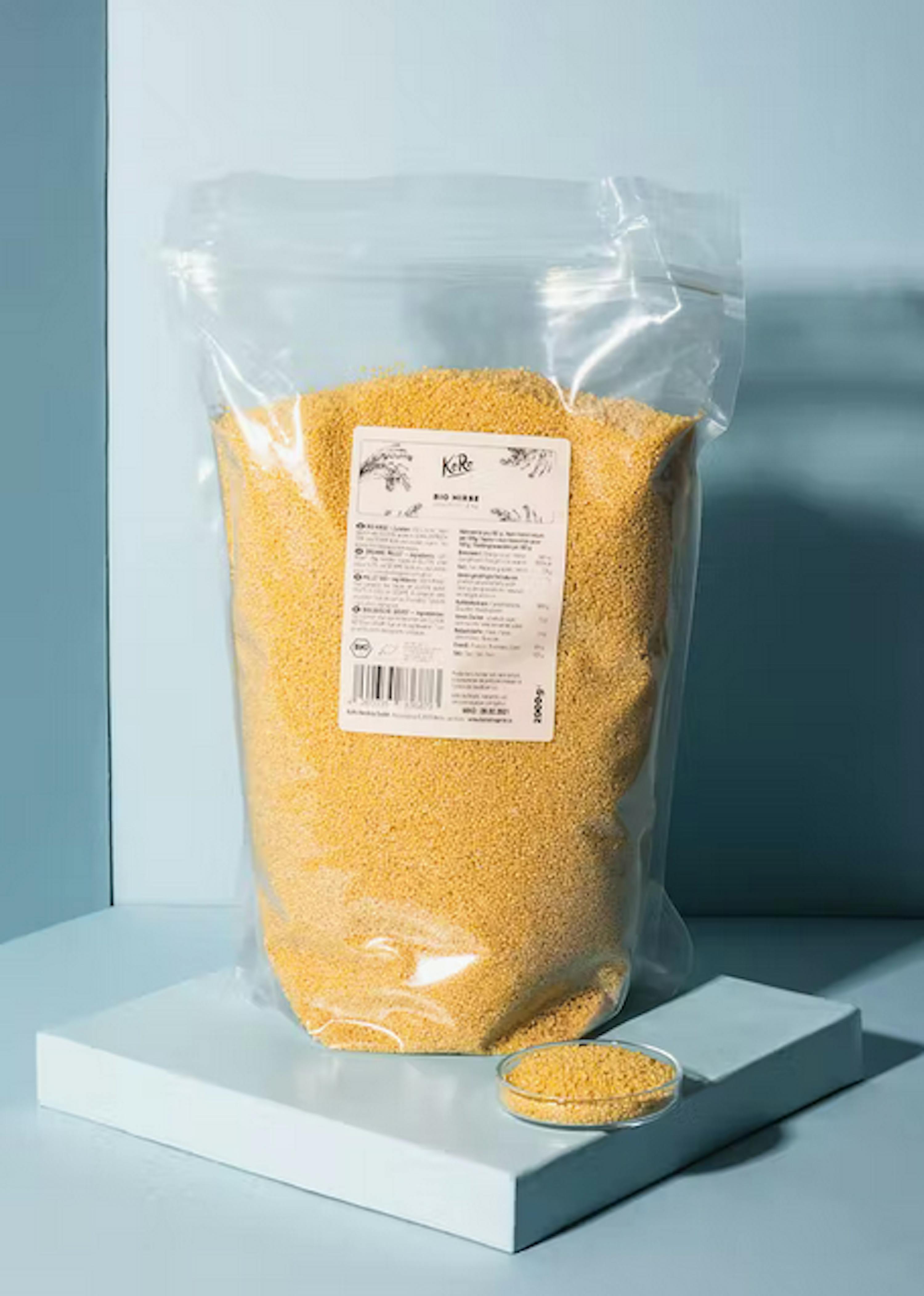 a bag of millet sits on a blue surface