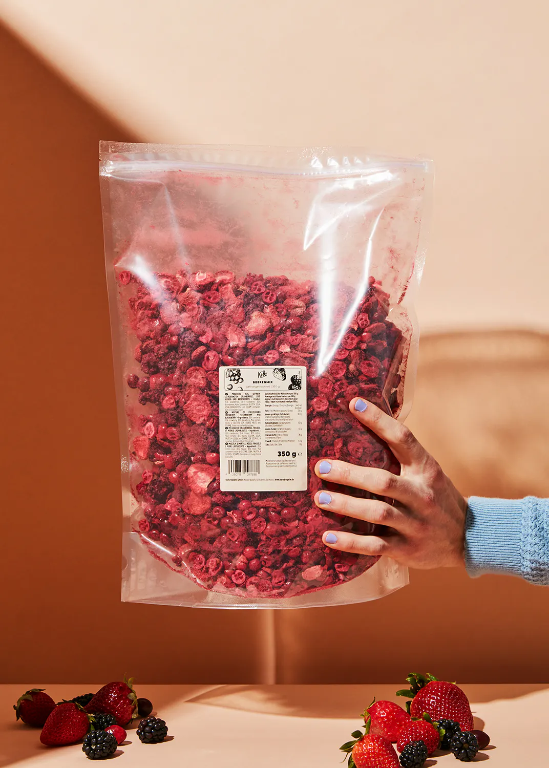 a person holding a bag of dried berries