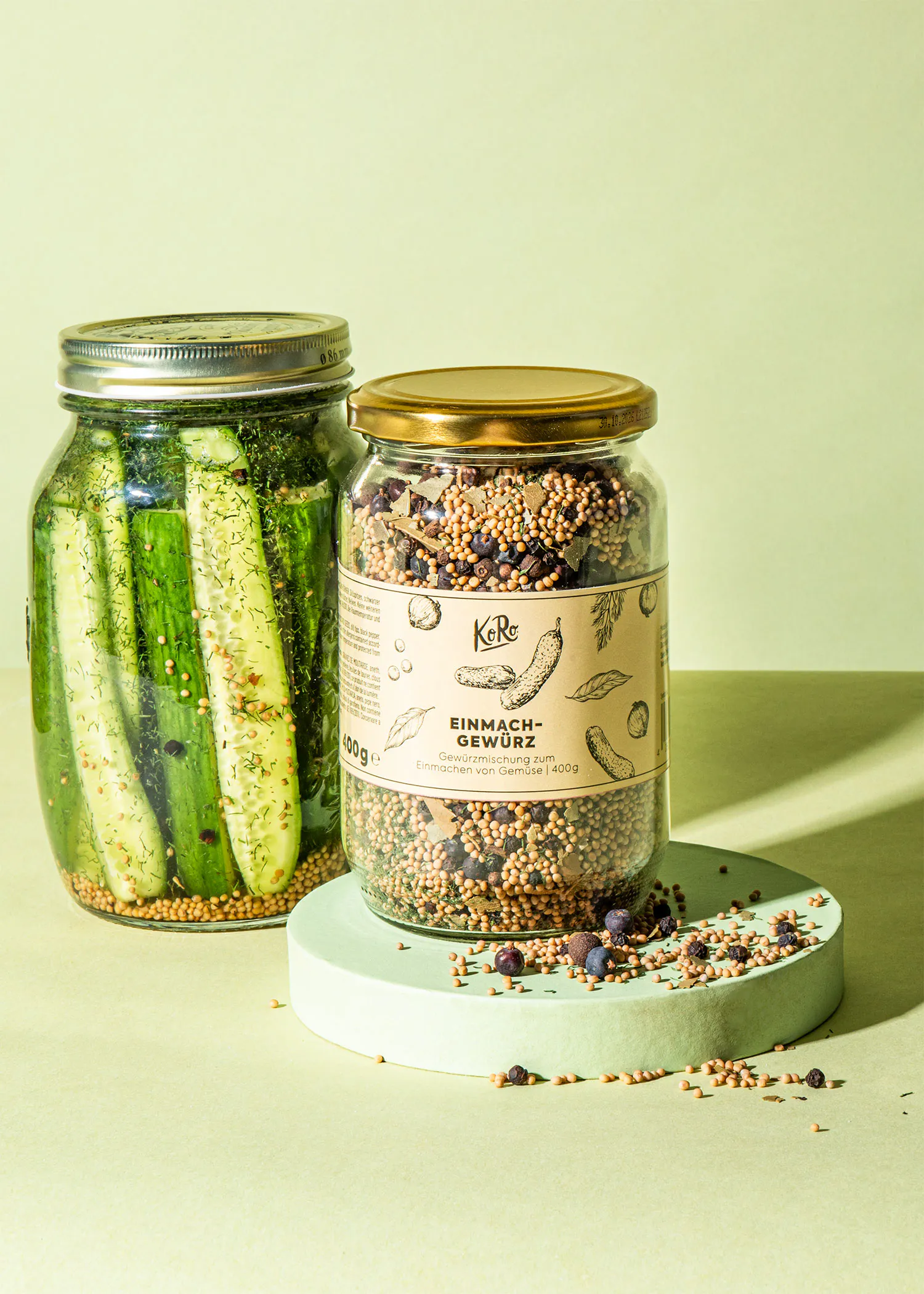 a jar of einmach gewurz sits next to a jar of pickles