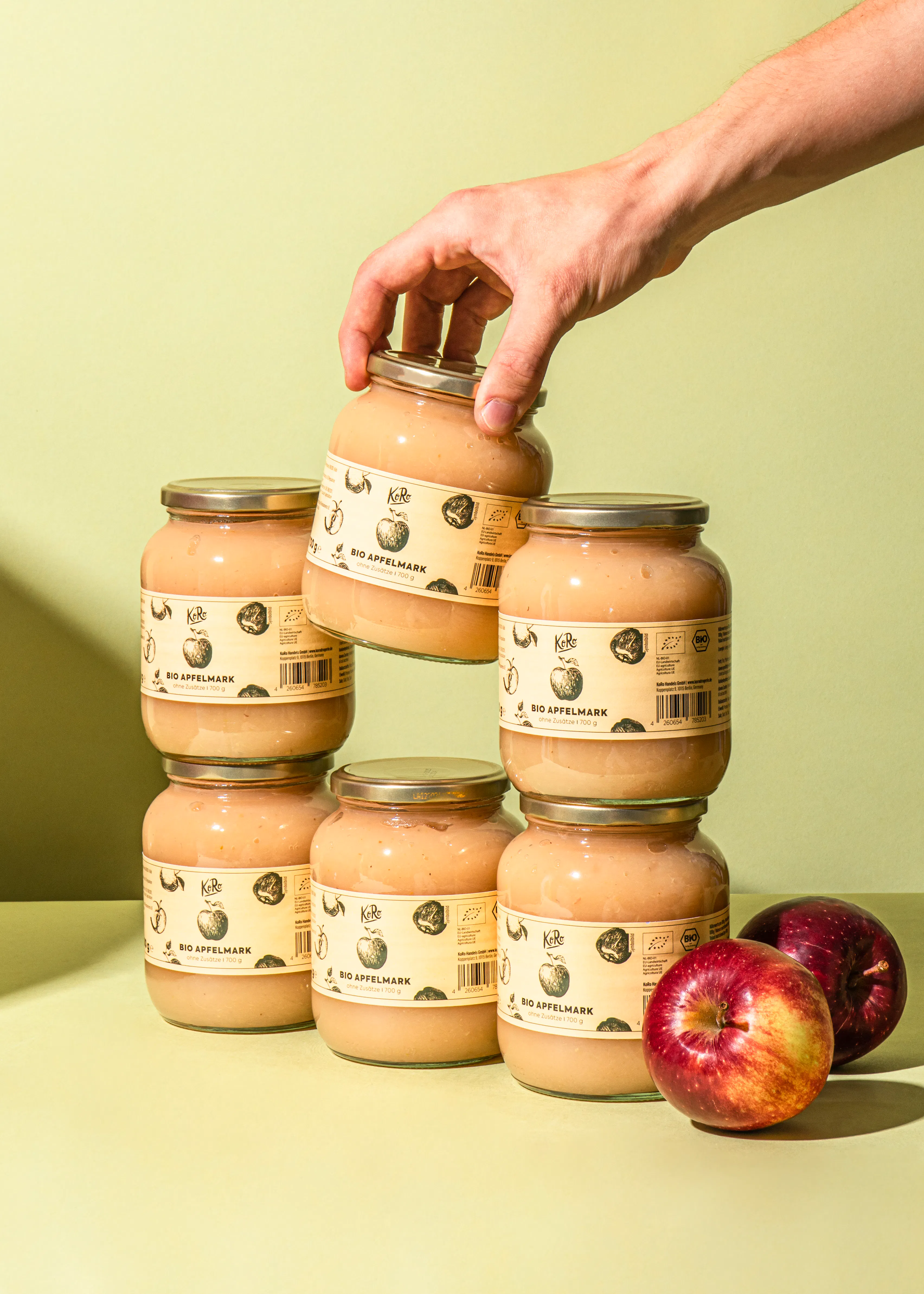 quatre bocaux de compote de pommes empilés les uns sur les autres