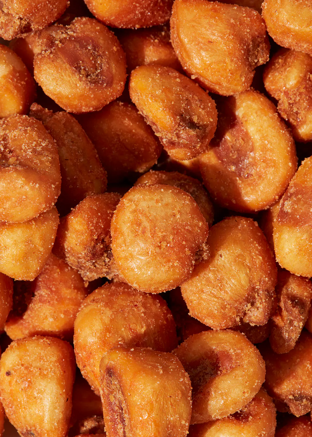 a pile of corn on the cob covered in powdered sugar