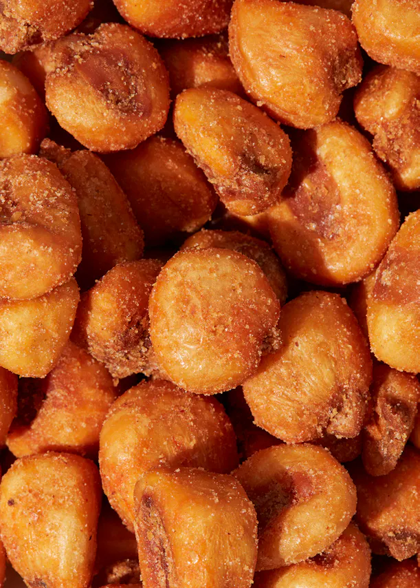 a pile of corn on the cob covered in powdered sugar