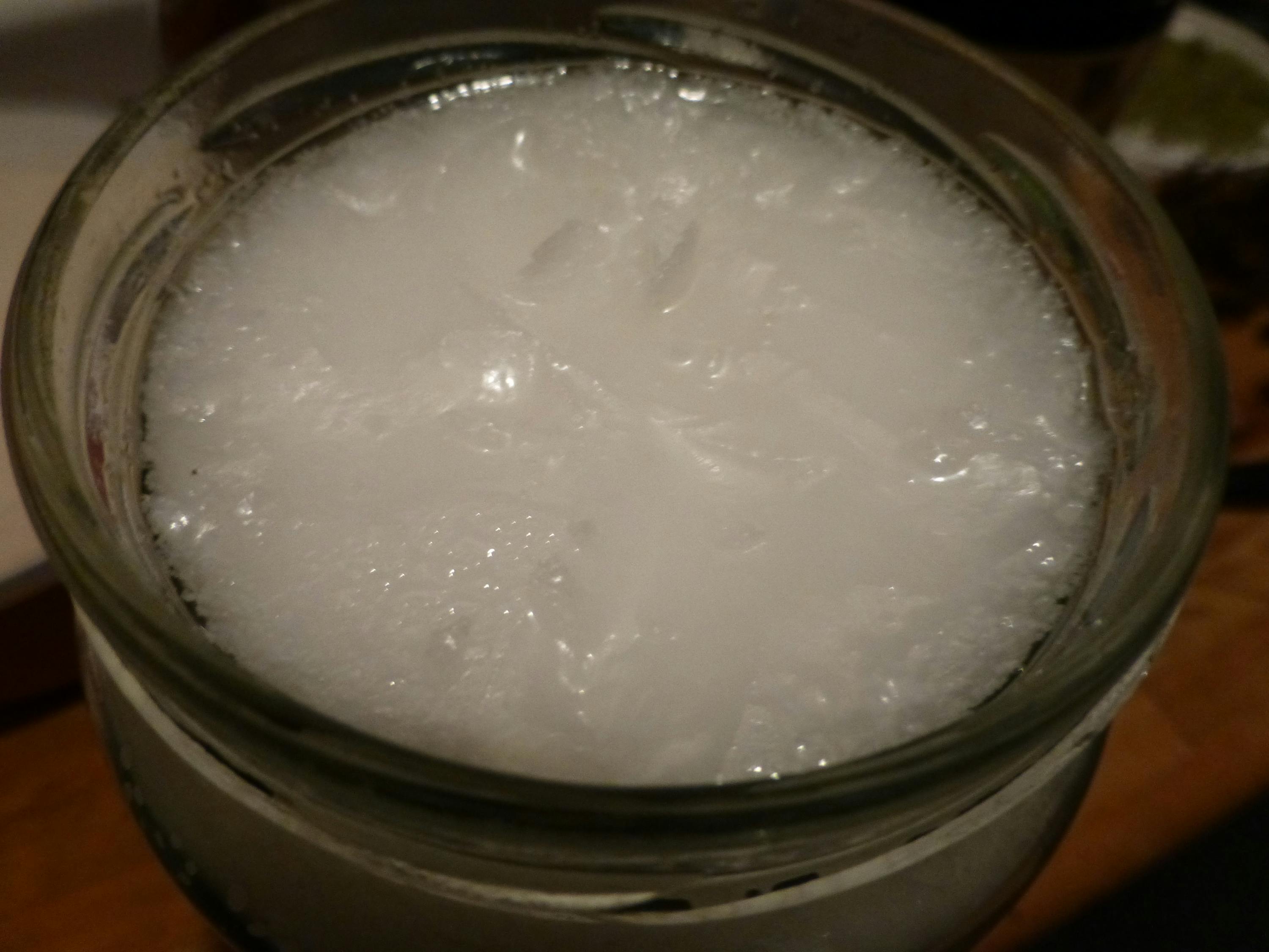 un gros plan d' un bocal en verre rempli d' un liquide blanc