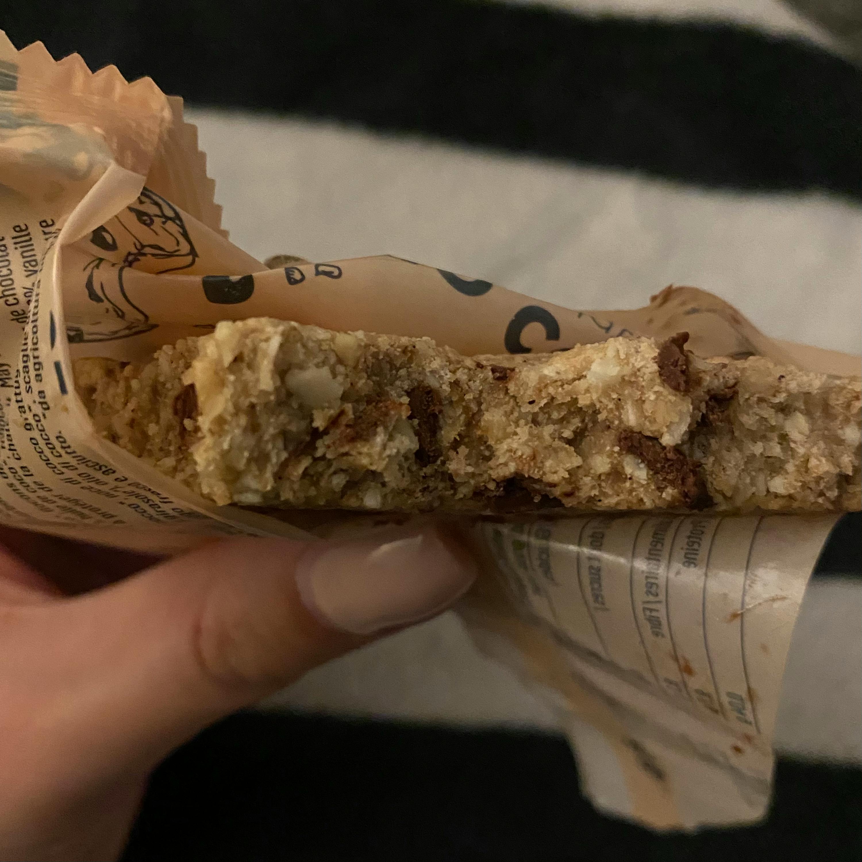 a person is holding a cookie in a bag that says chocolate on it