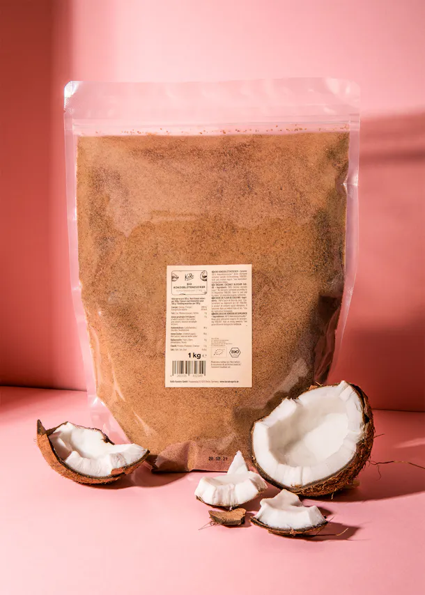 a bag of coconut sugar sits on a pink surface