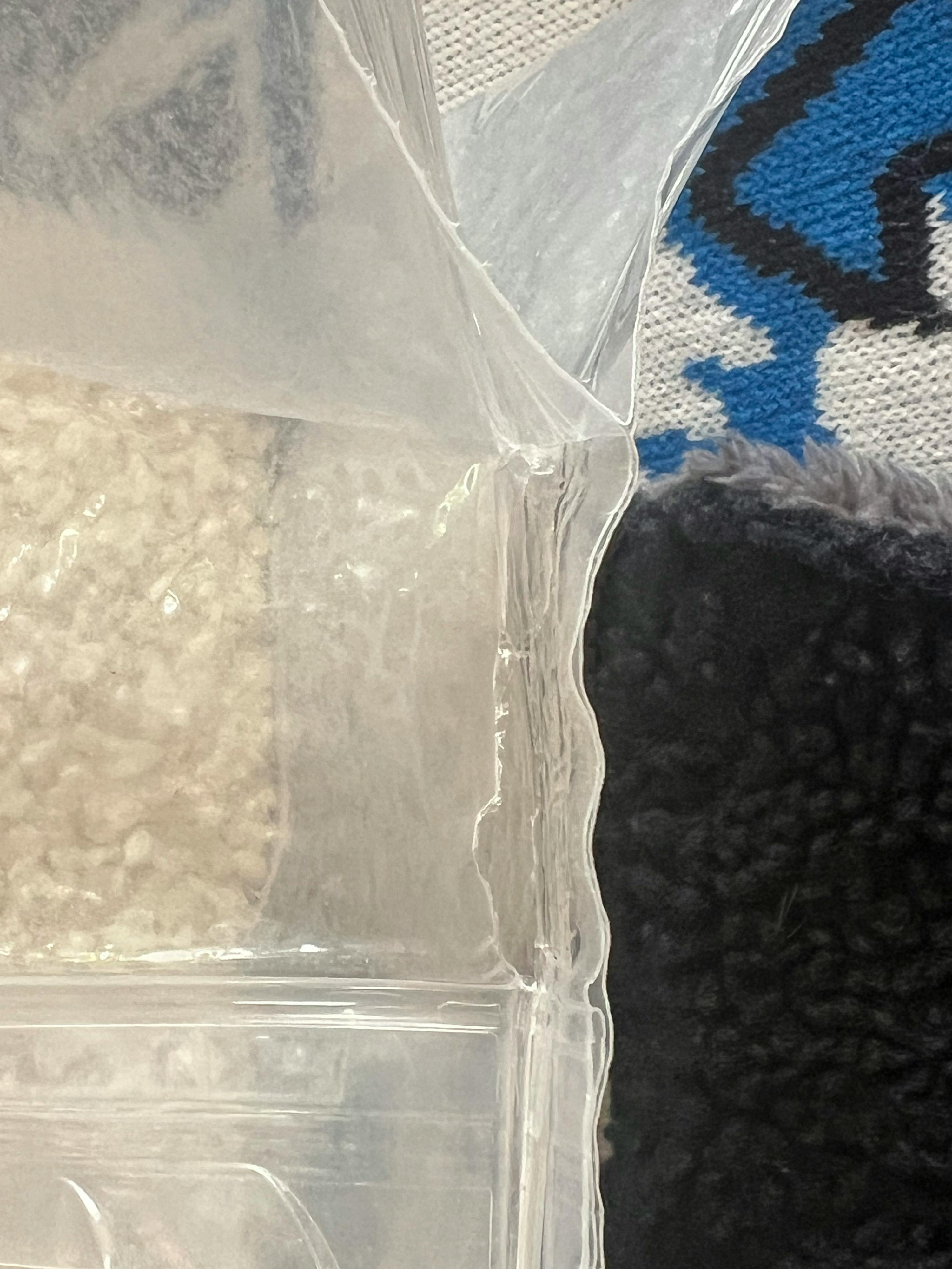 a clear plastic bag is sitting on a carpet