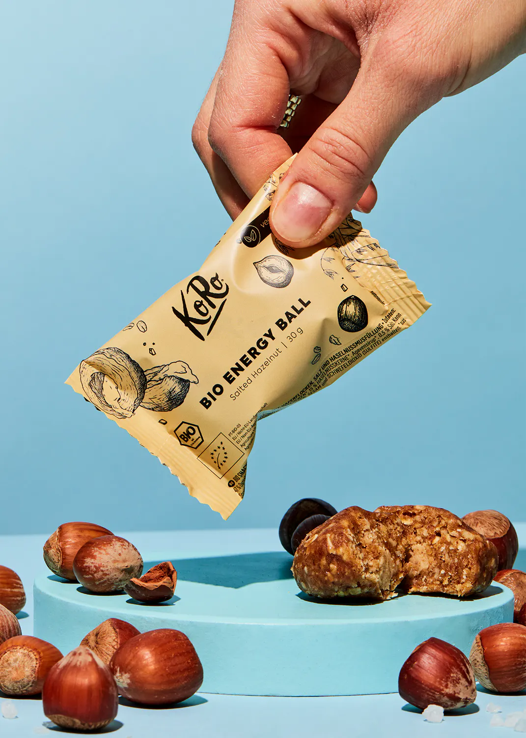 a person is holding a bio energy ball surrounded by nuts