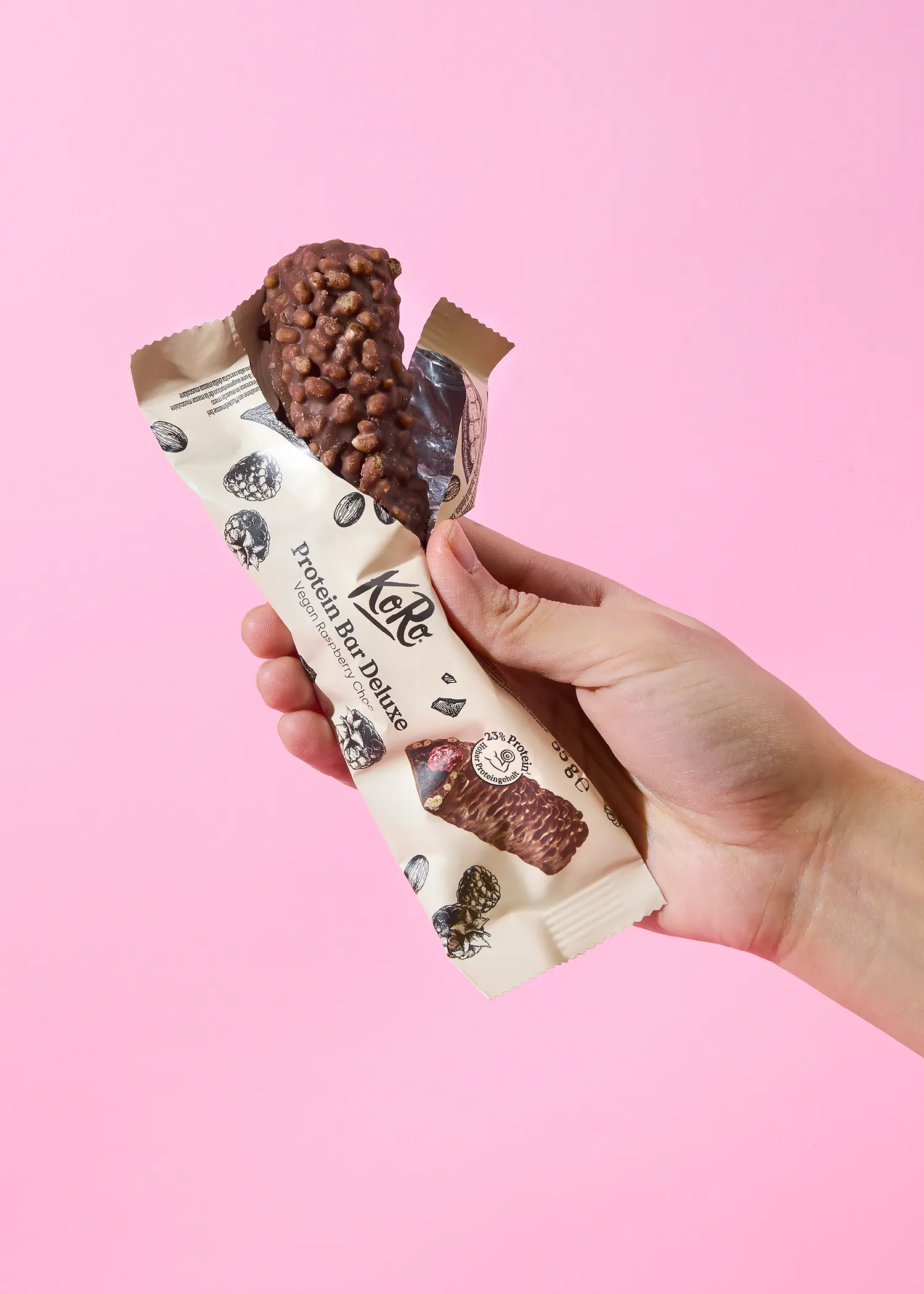 a person is holding a protein bar in their hand