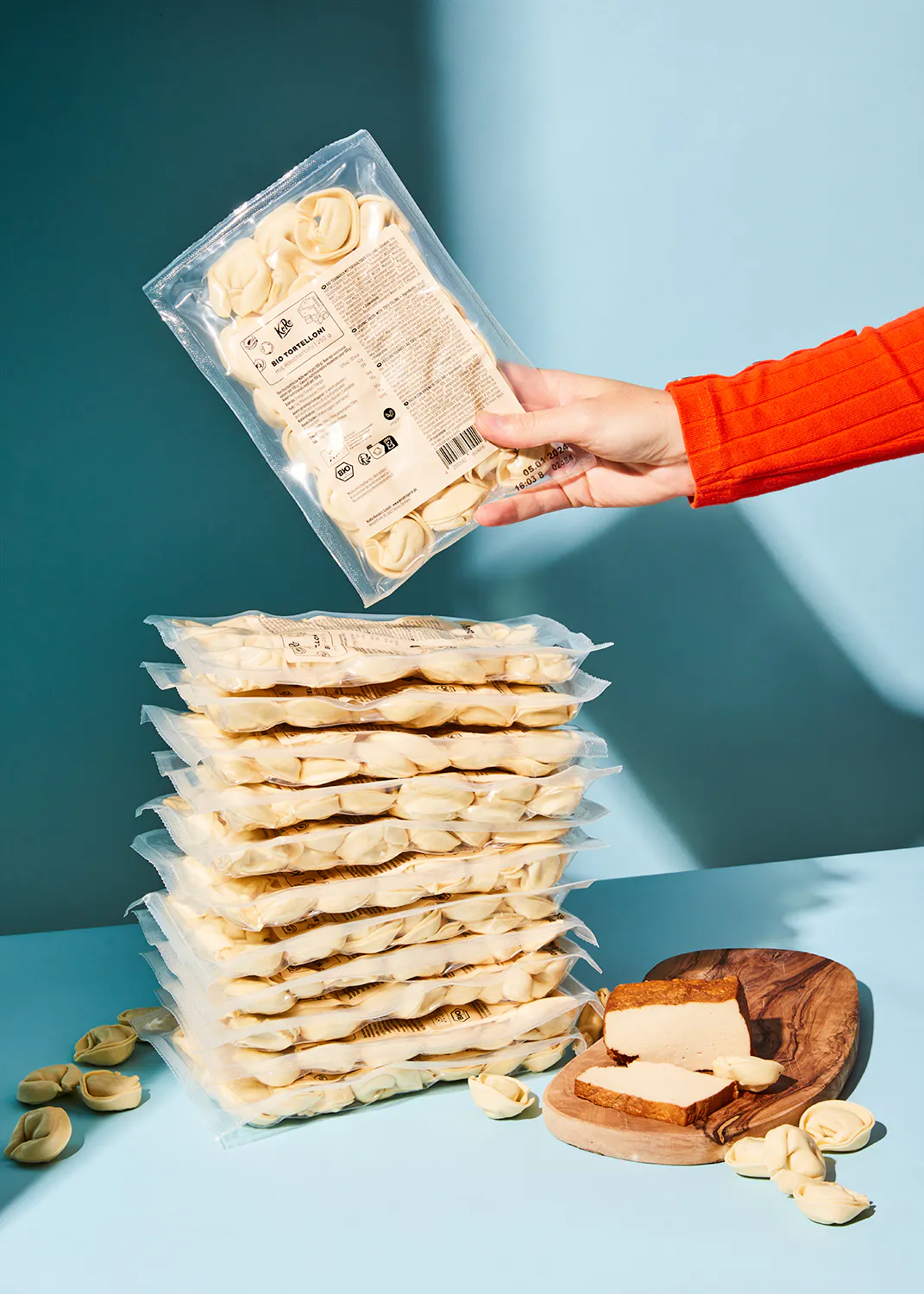 a person is holding a bag of pierogies in their hands