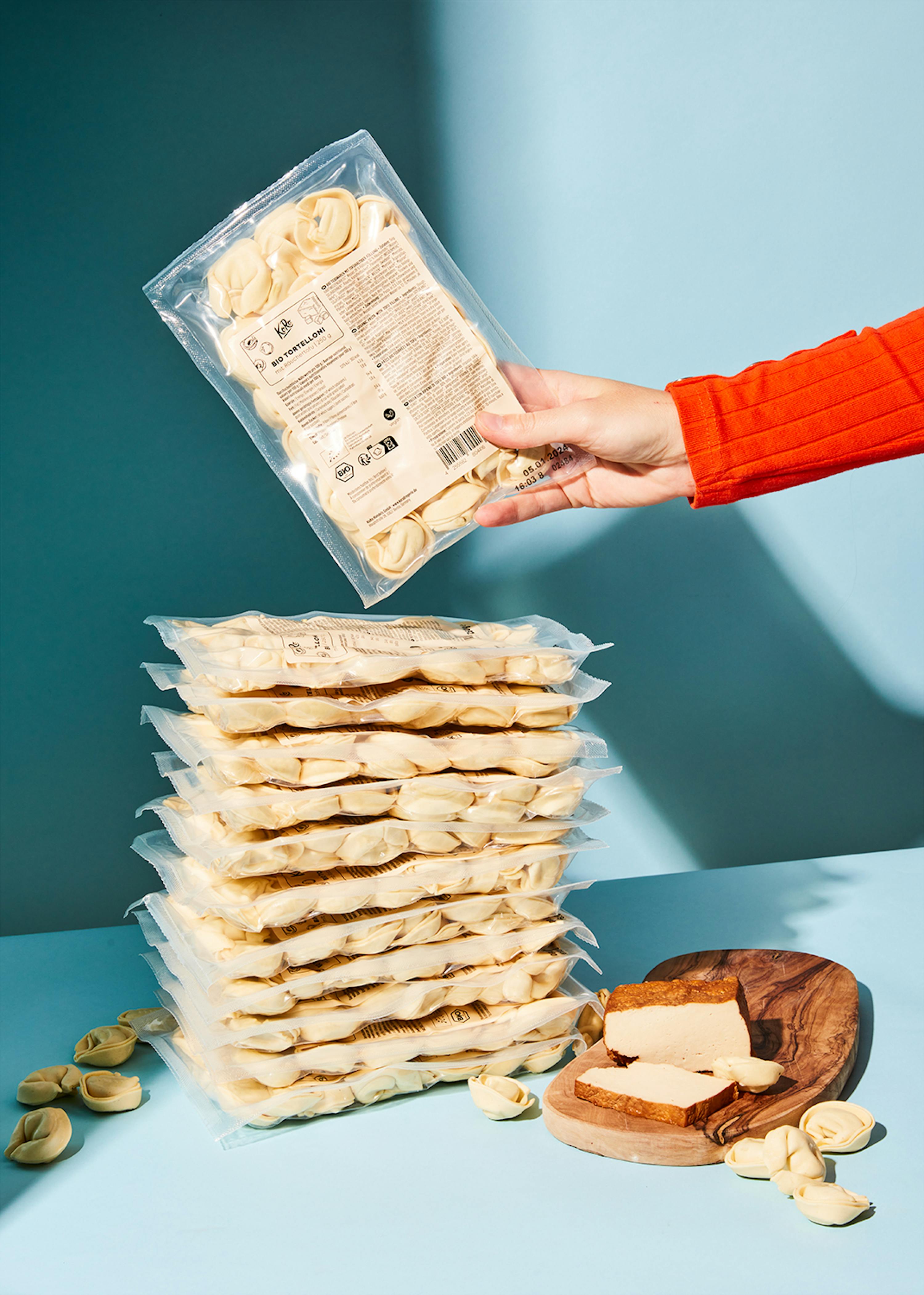 a person is holding a bag of pierogies in their hands