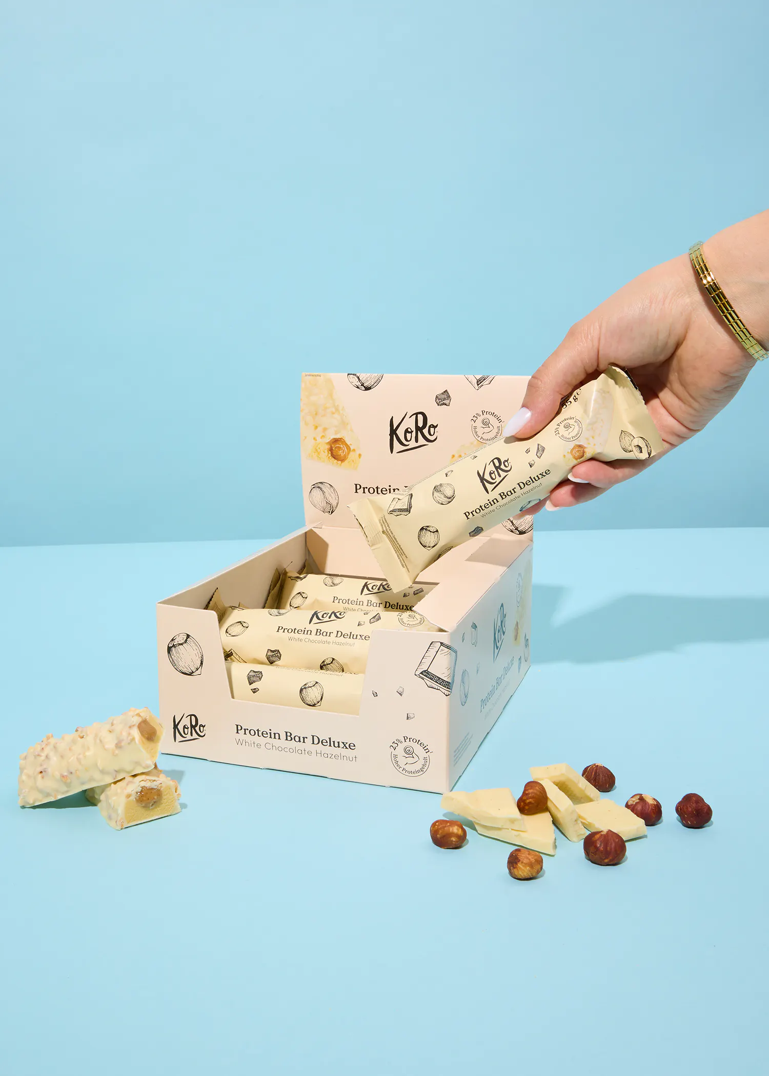 a person is holding a white protein bar in their hand