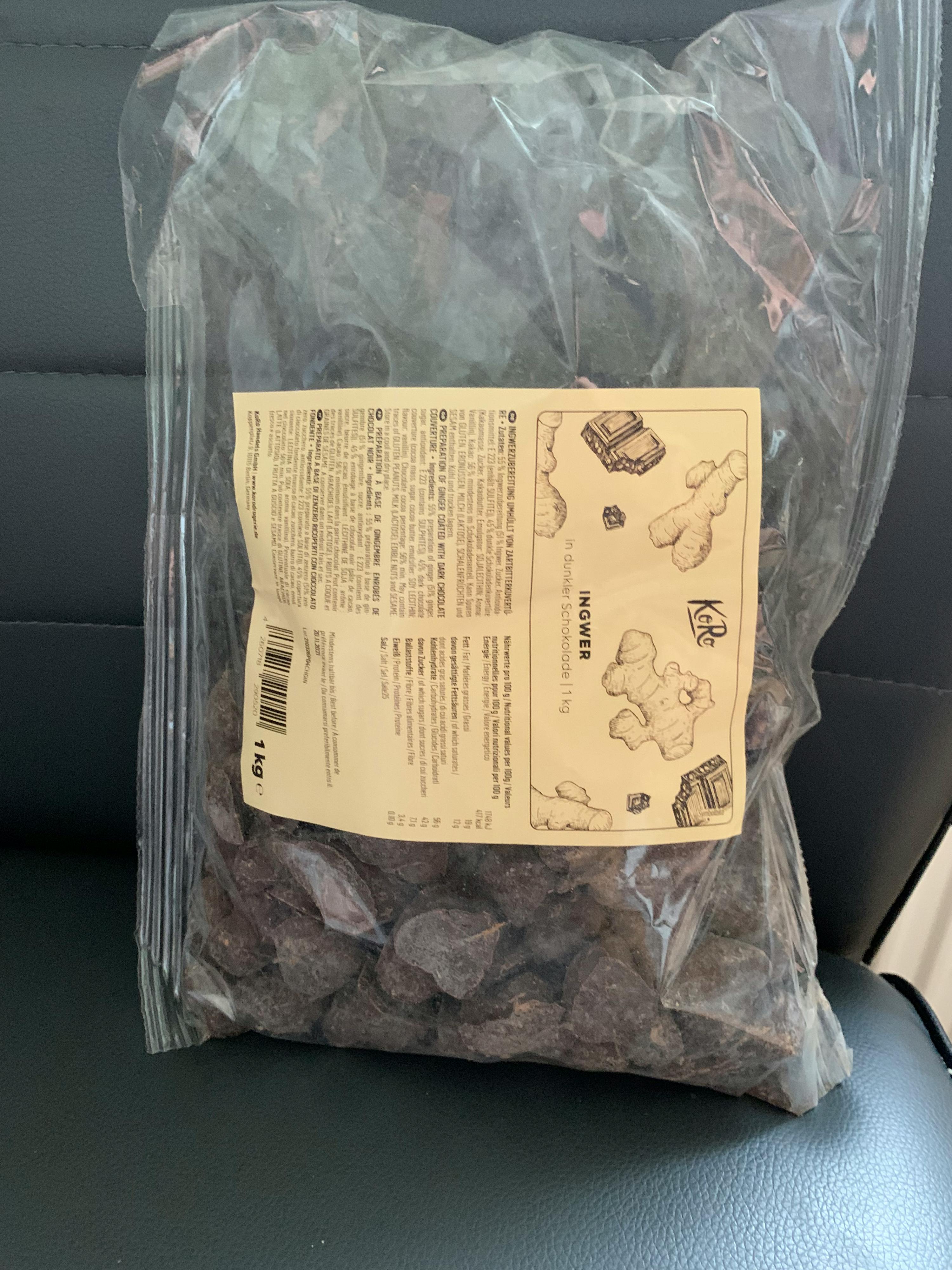 a bag of ginger sits on a black leather couch