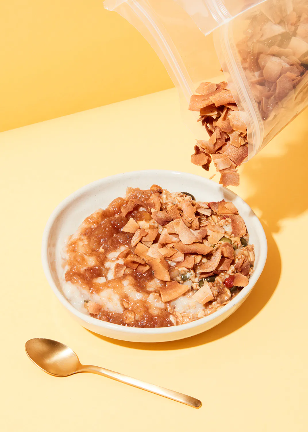 a plate of food with coconut flakes and a spoon