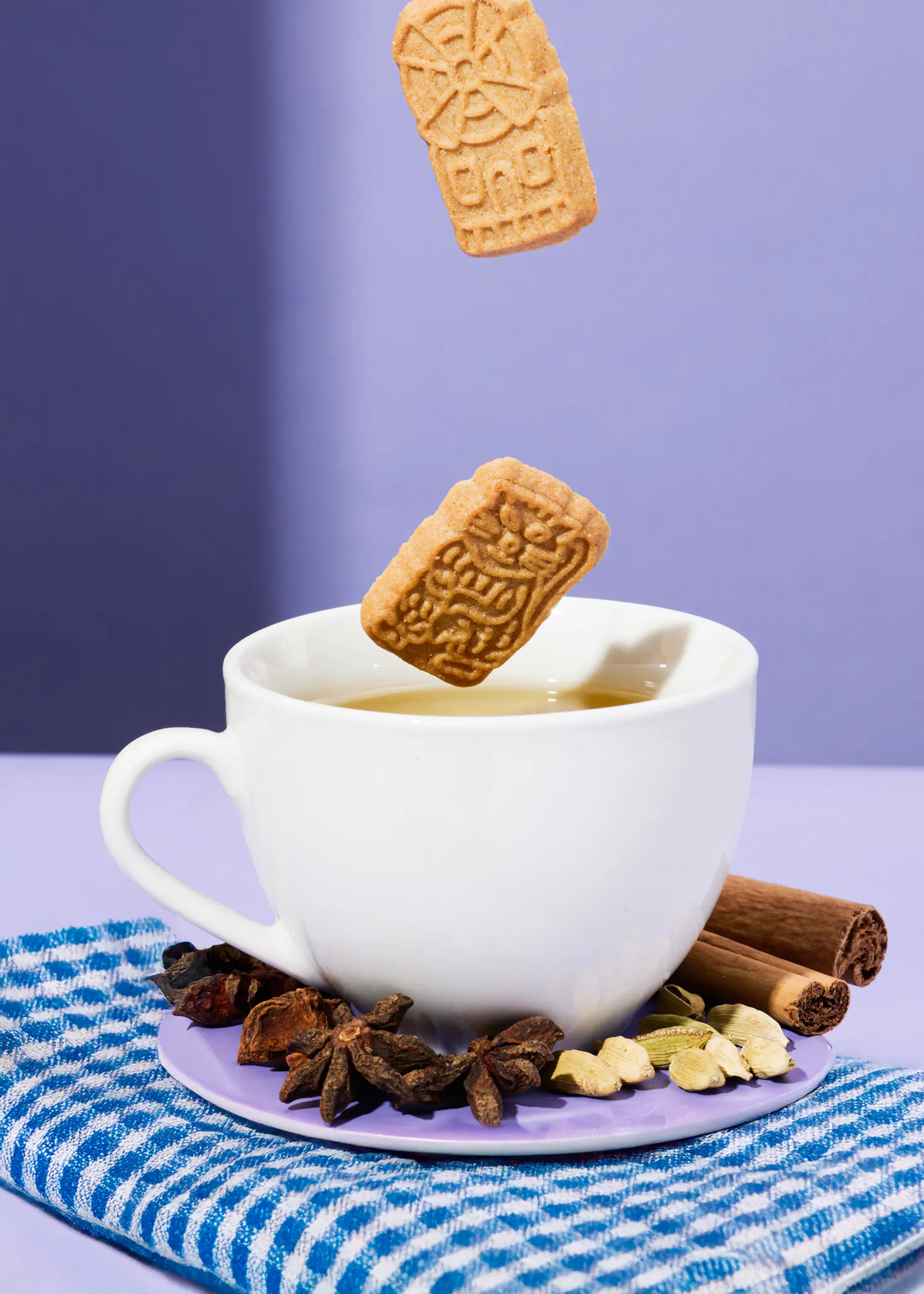 a cup of tea with a cookie that says ' stroopwafels ' on it