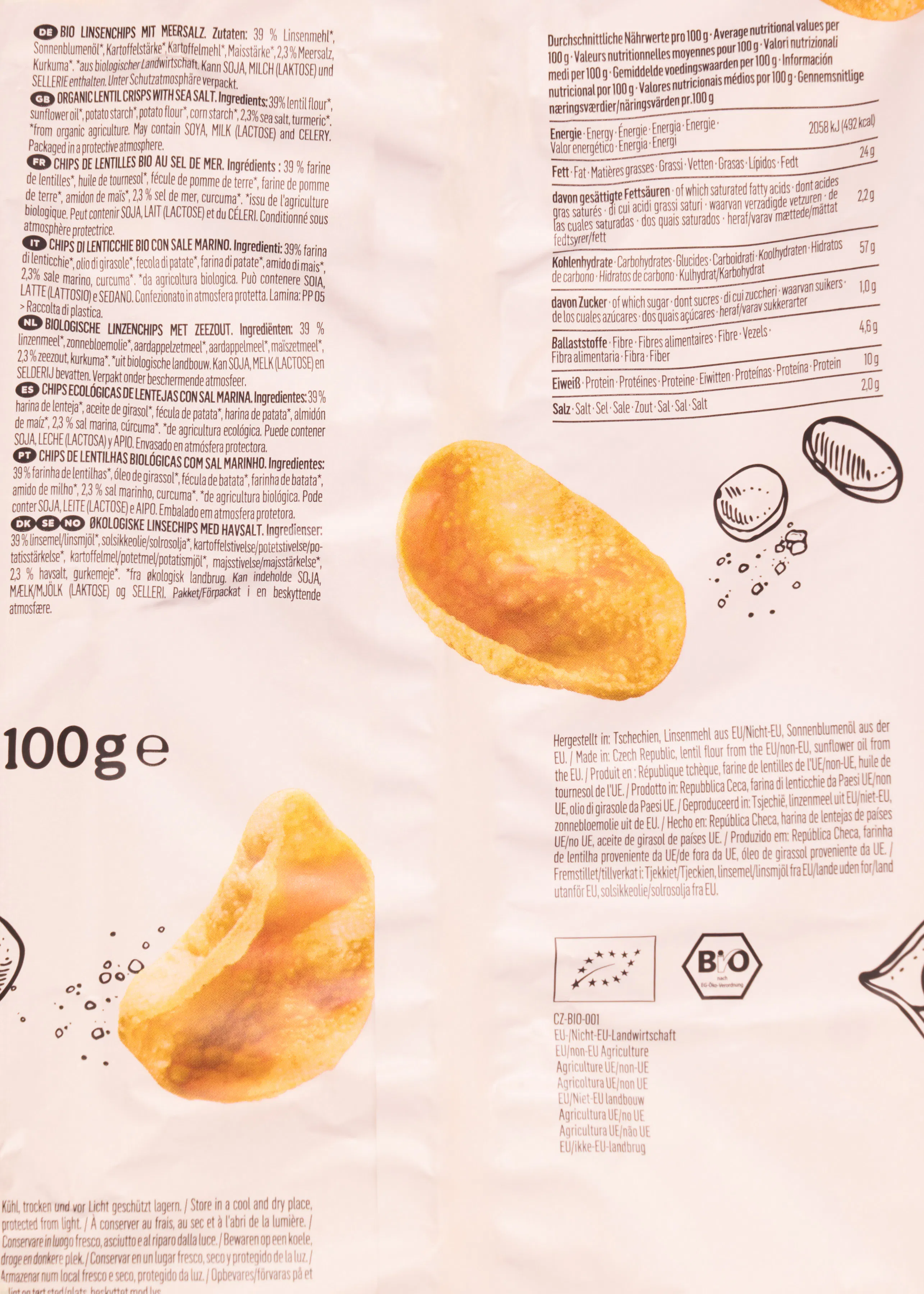 die rückseite einer verpackung für bio-linsenchips mit nährwerttabelle, zutatenliste in mehreren sprachen und einem produktfoto von zwei runden chips.