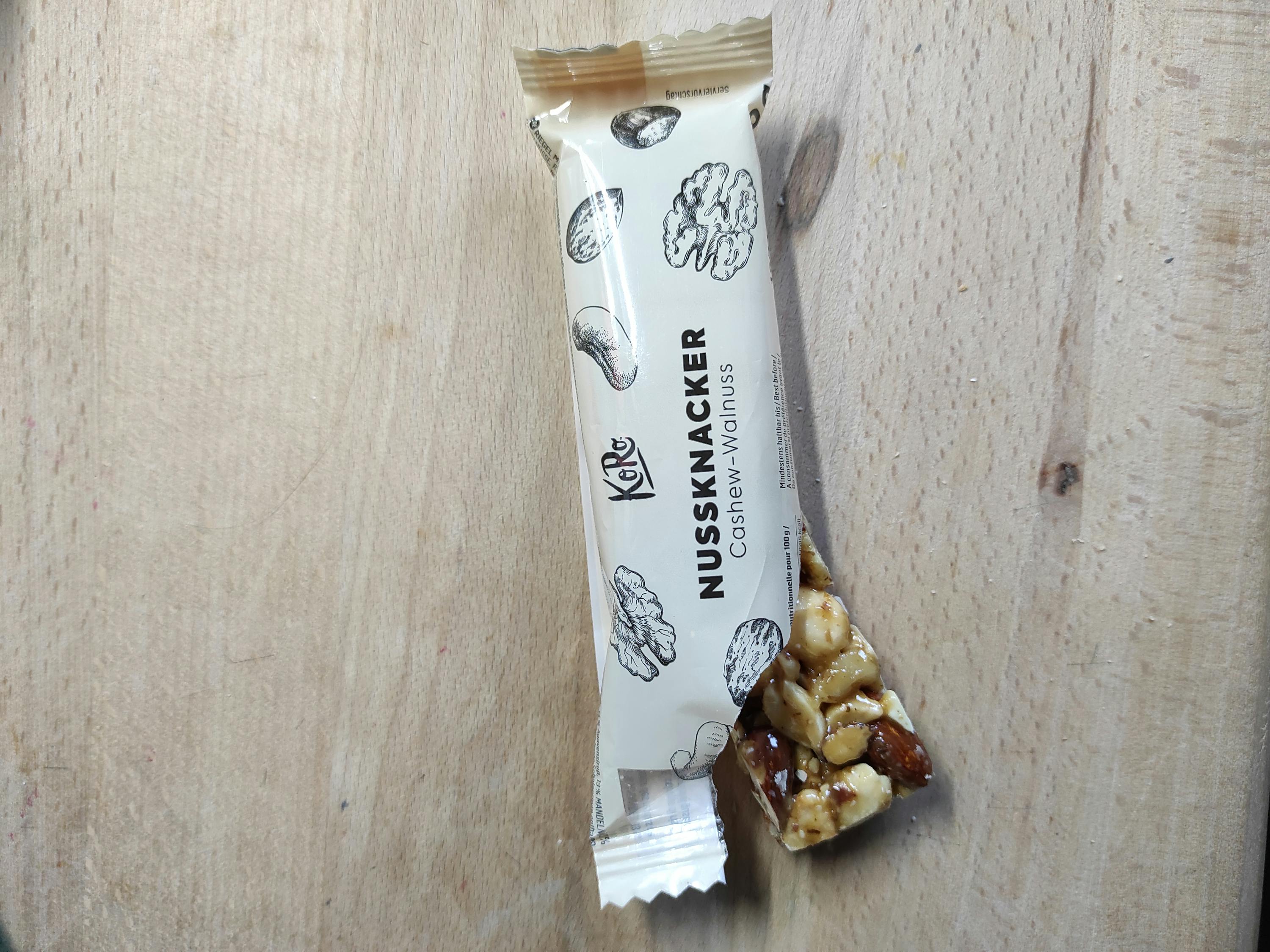 a nussknacker cashew-walnuss bar is sitting on a wooden table