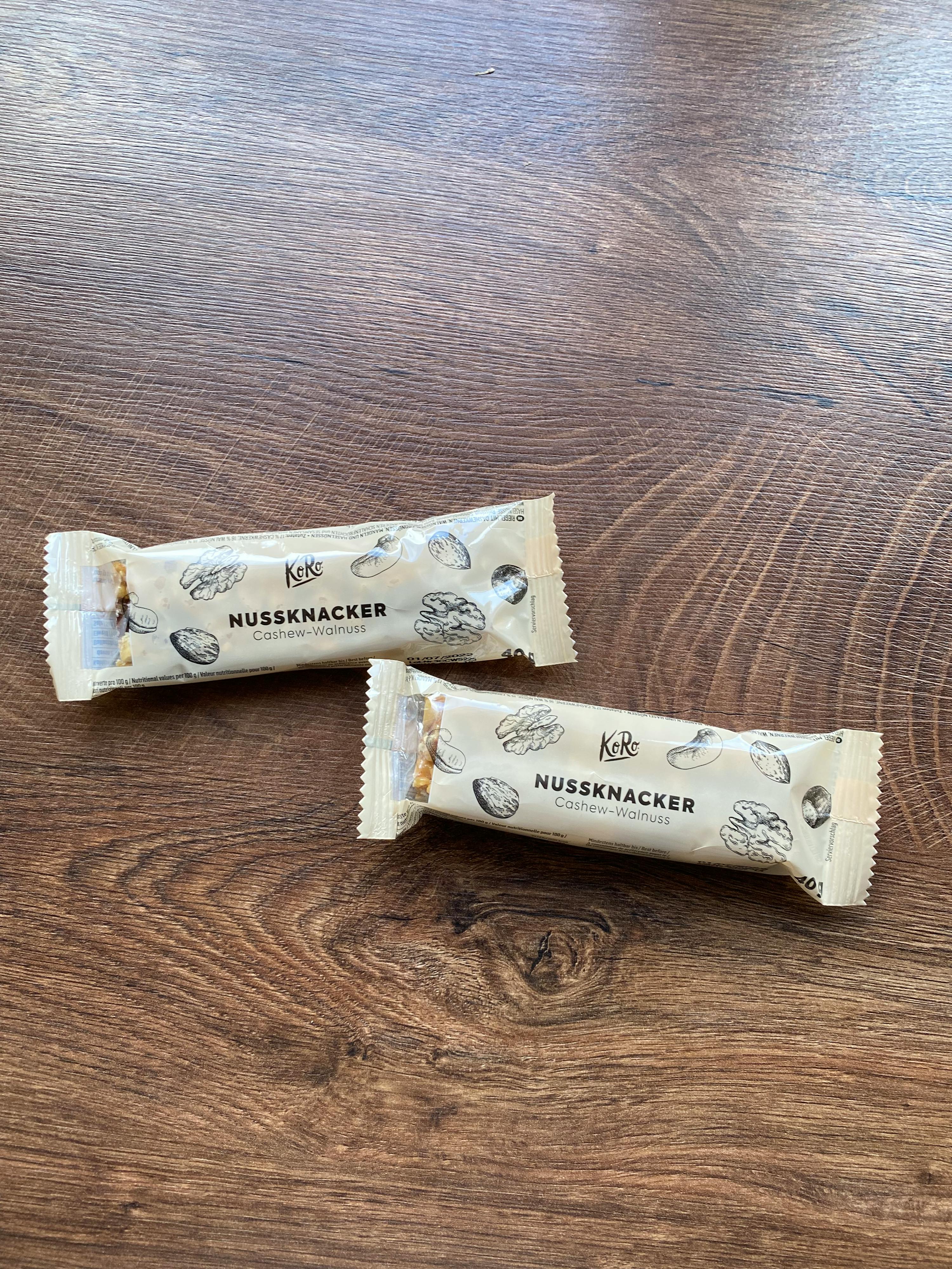 two packages of nussnacker bars on a wooden table