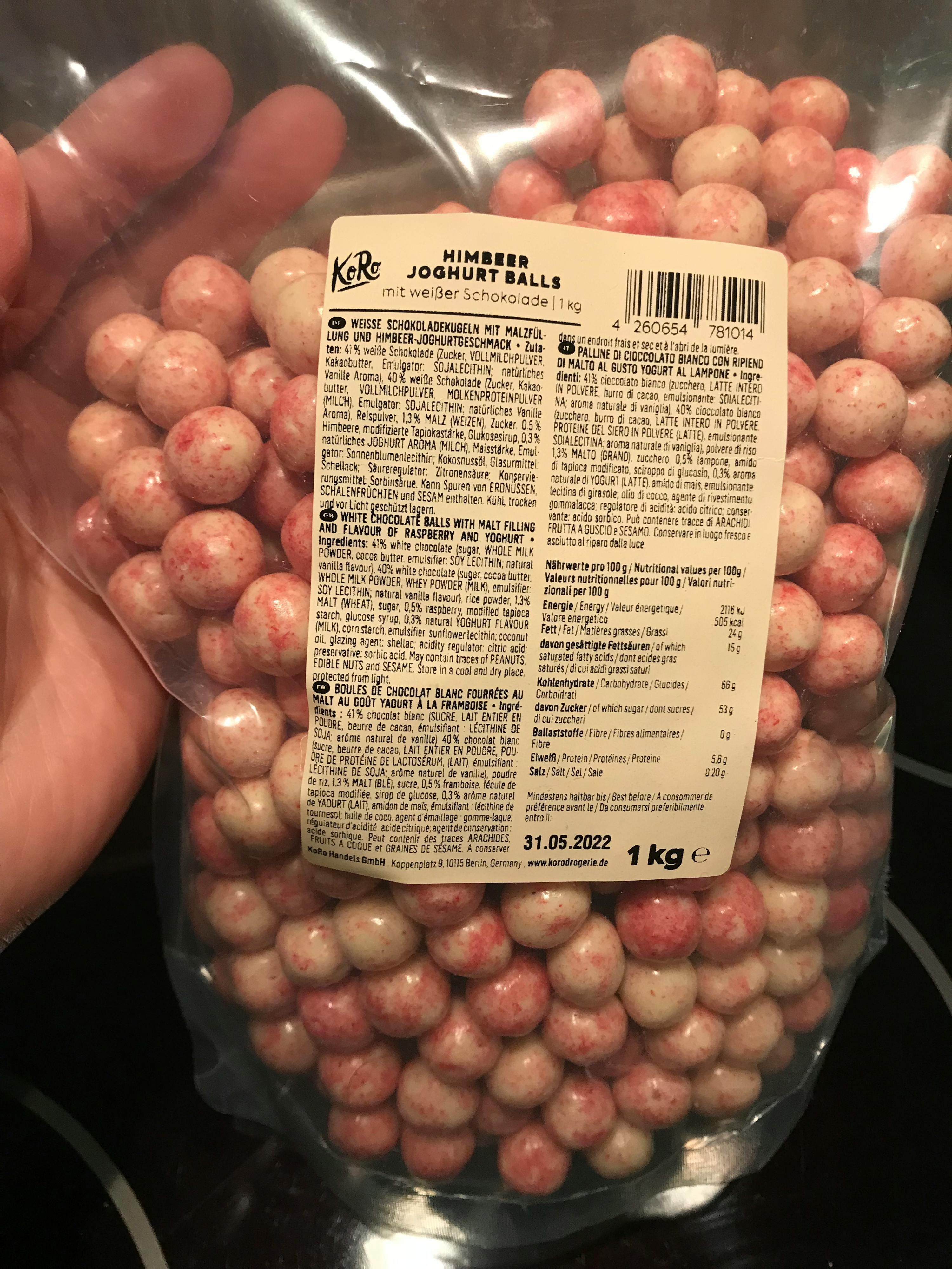 a person holding a bag of pink and white candy