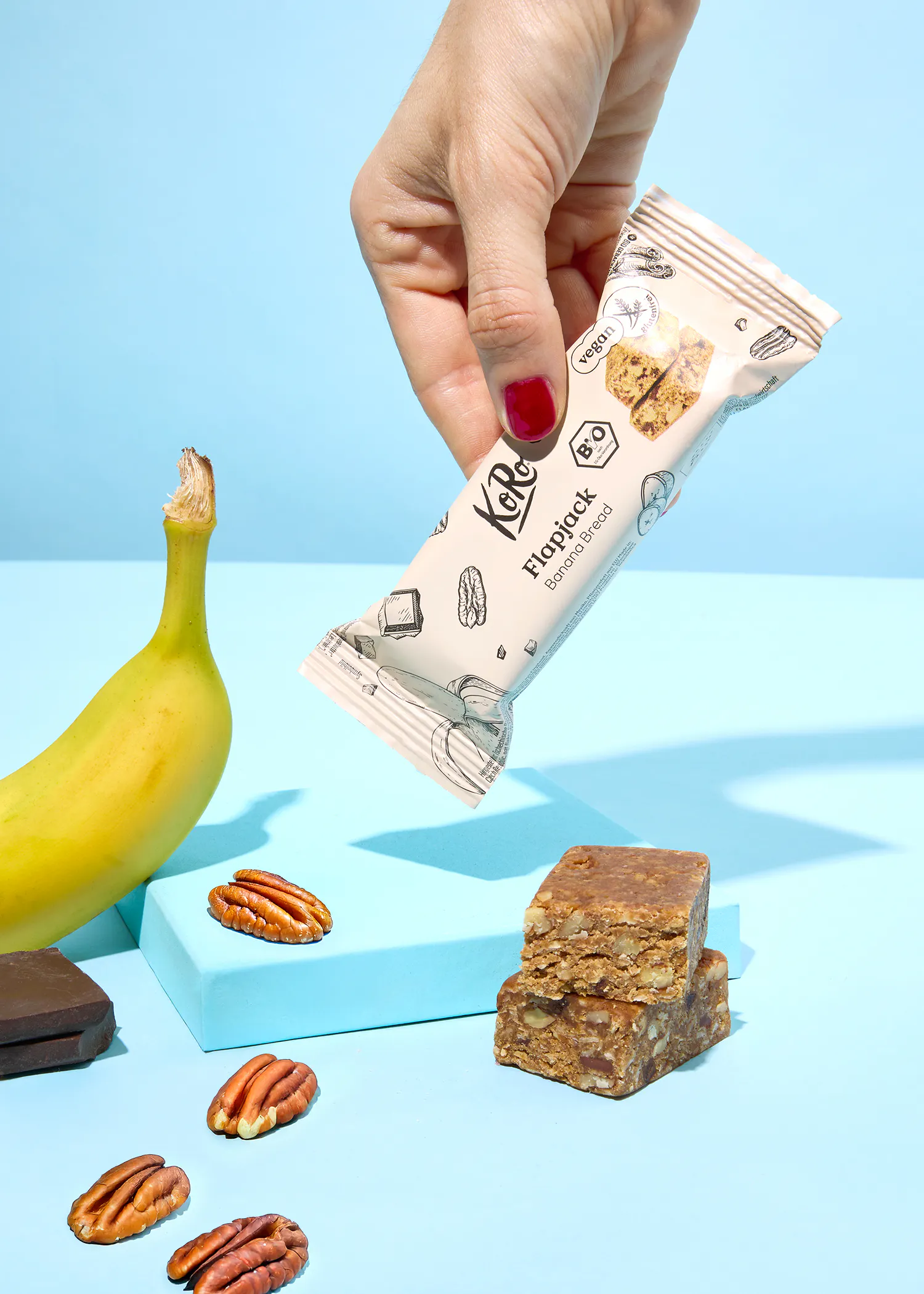 une personne tient une barre flippack banane et noix de pécan