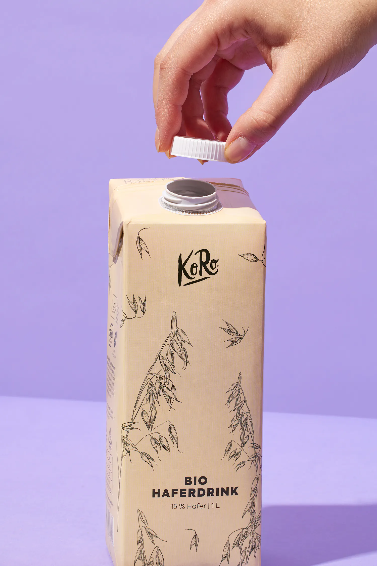 a person is opening a box of bio haferdrink