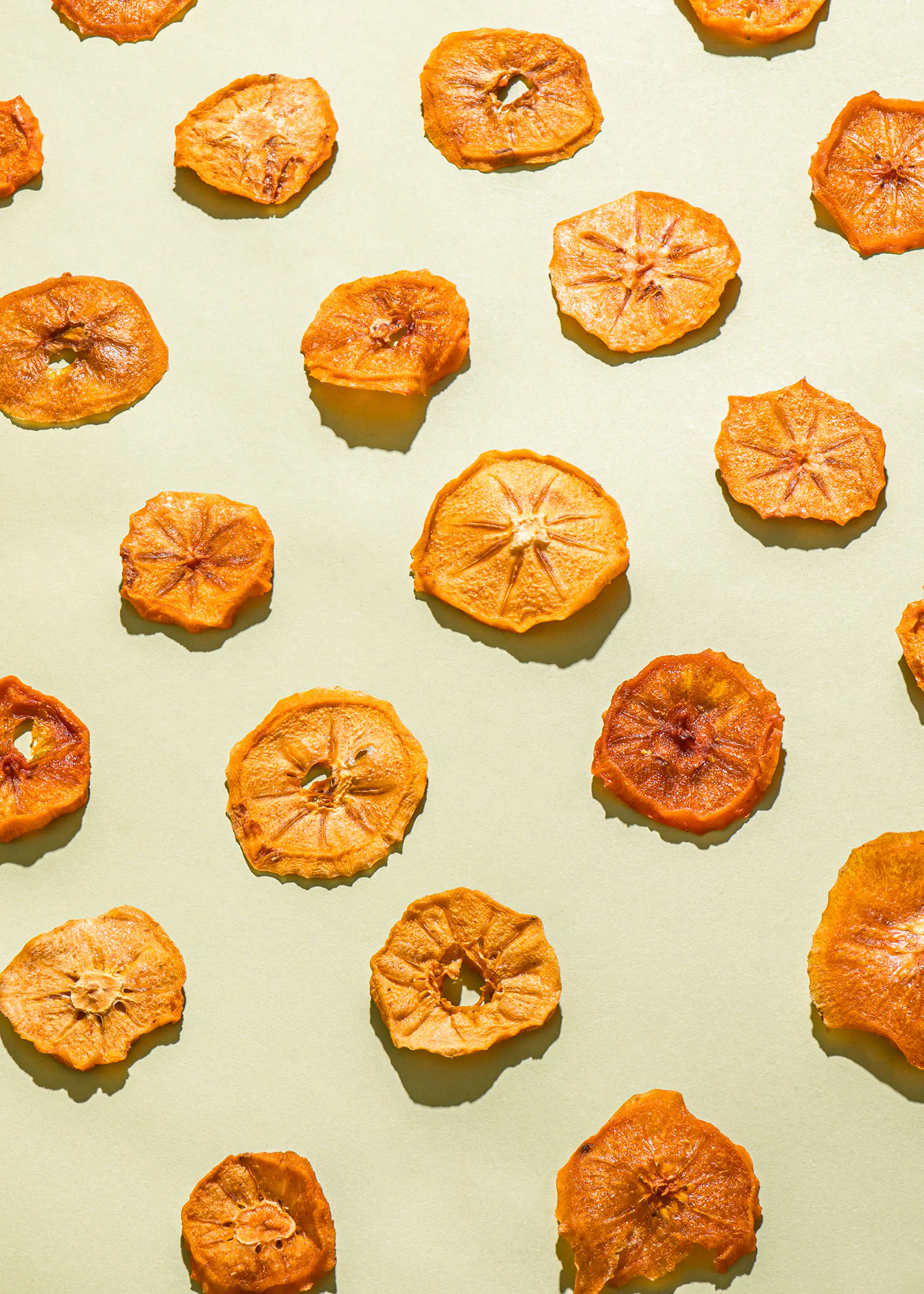 a pattern of dried apple slices on a green background