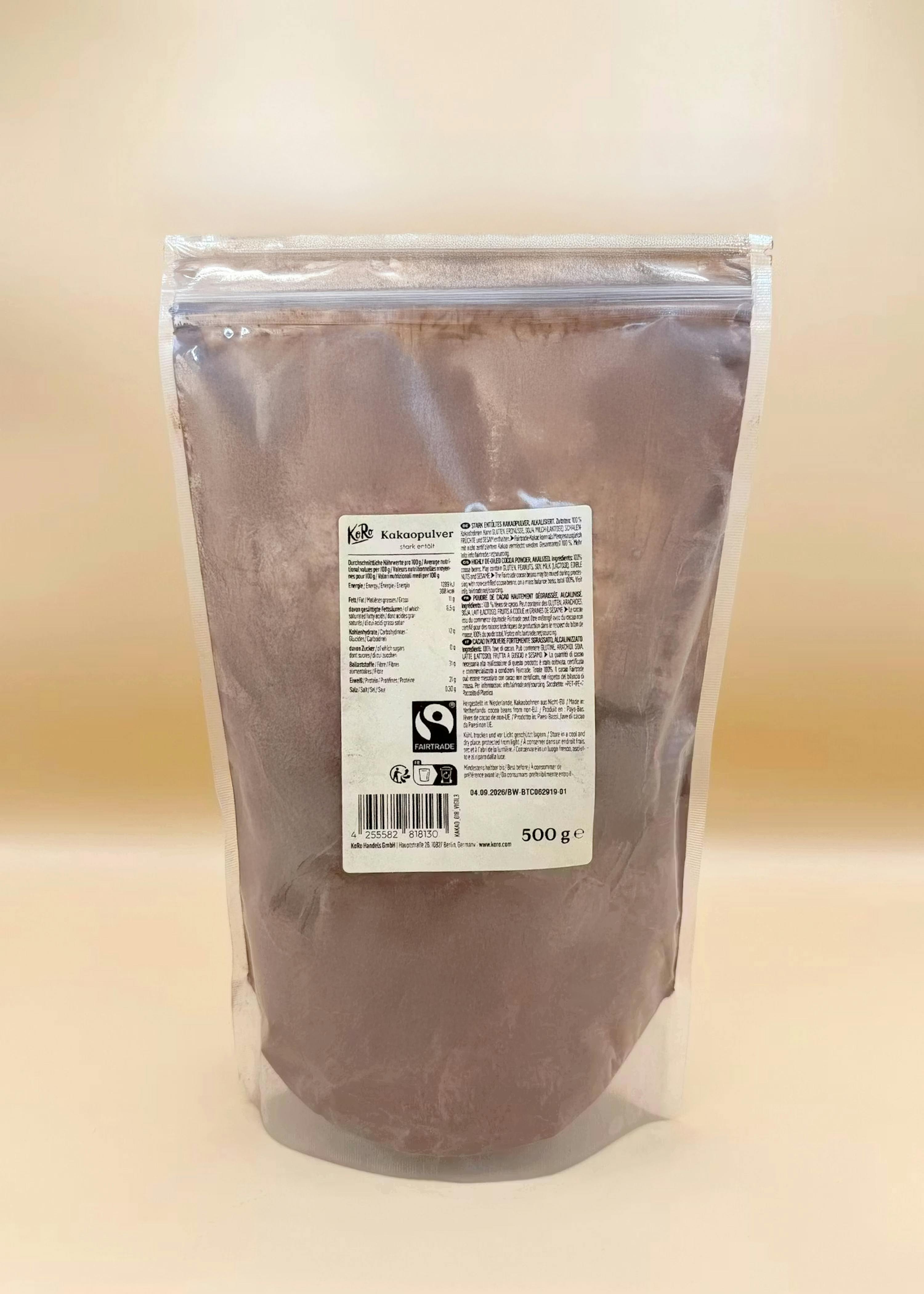 eine durchsichtige plastiktüte mit koro kakaopulver, das ein fairtrade-logo und die angabe 500g enthält.