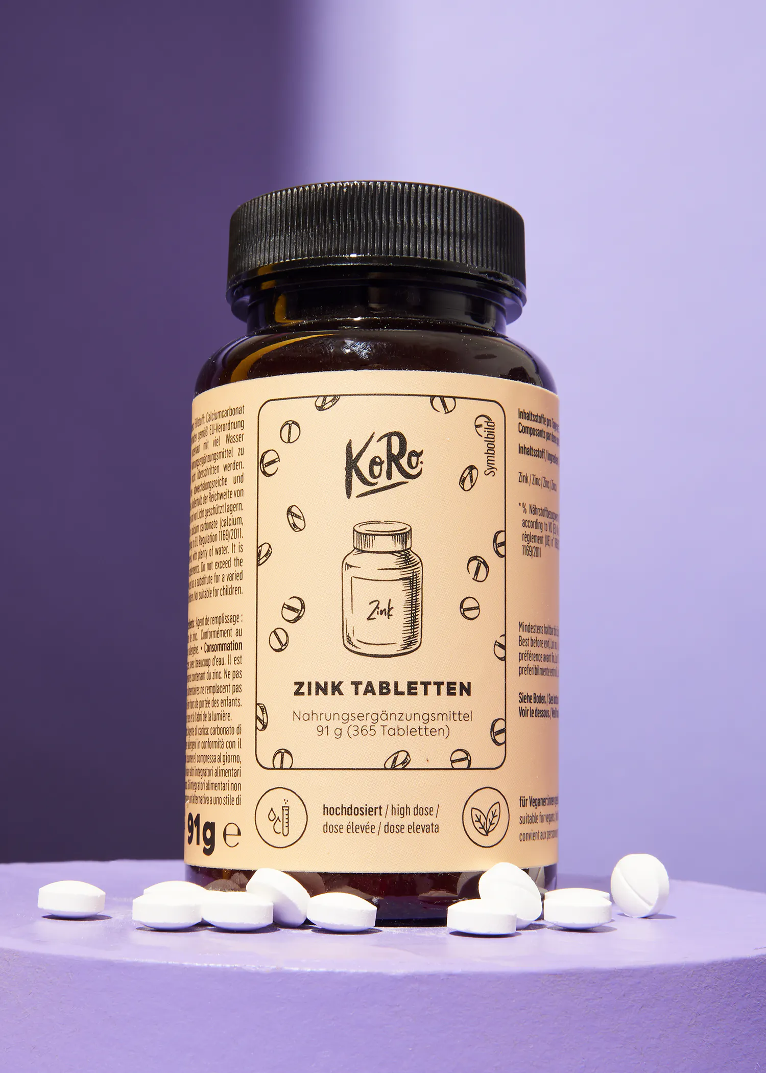 a bottle of koro zink tabletten on a purple surface