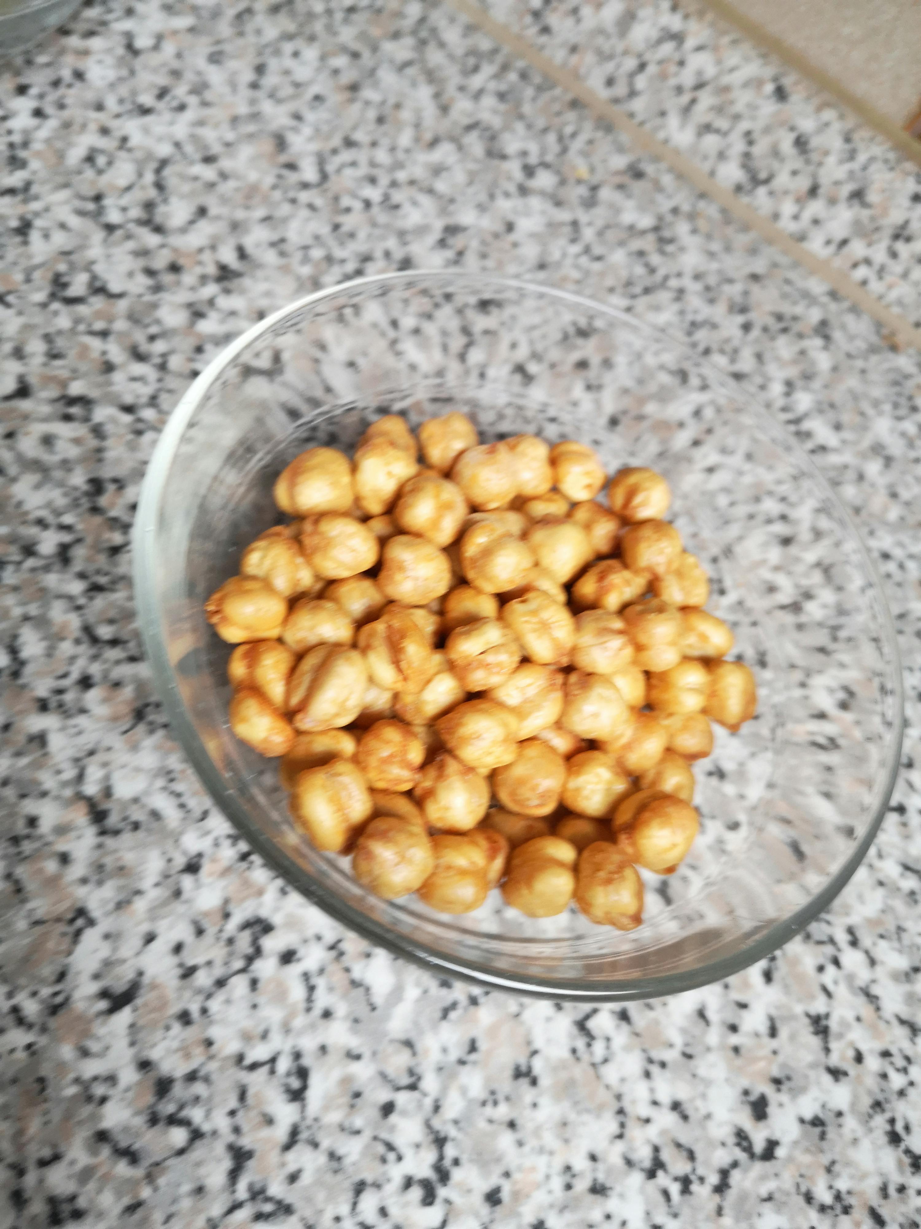 a bowl of chickpeas sits on a granite counter