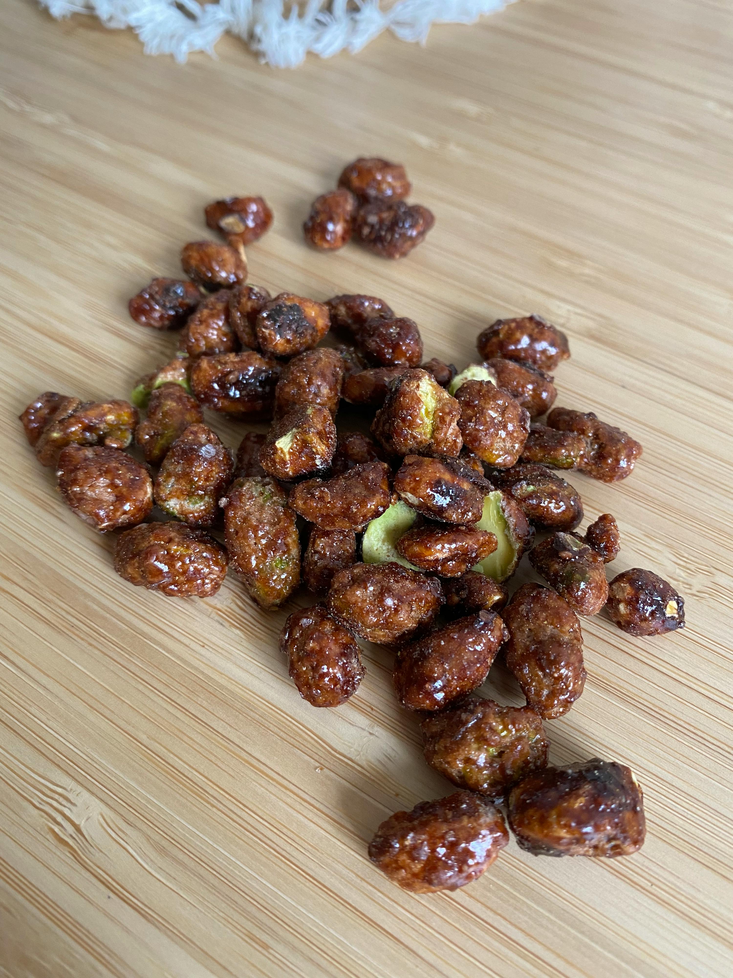 a pile of nuts on a wooden cutting board