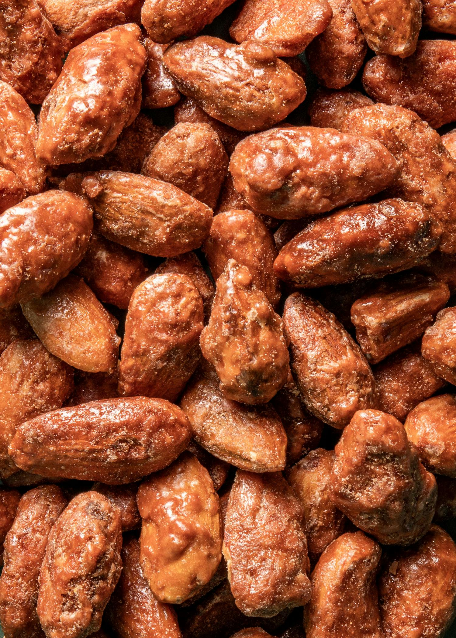 Candied almonds 1kg a close up of a pile of nuts covered in sauce