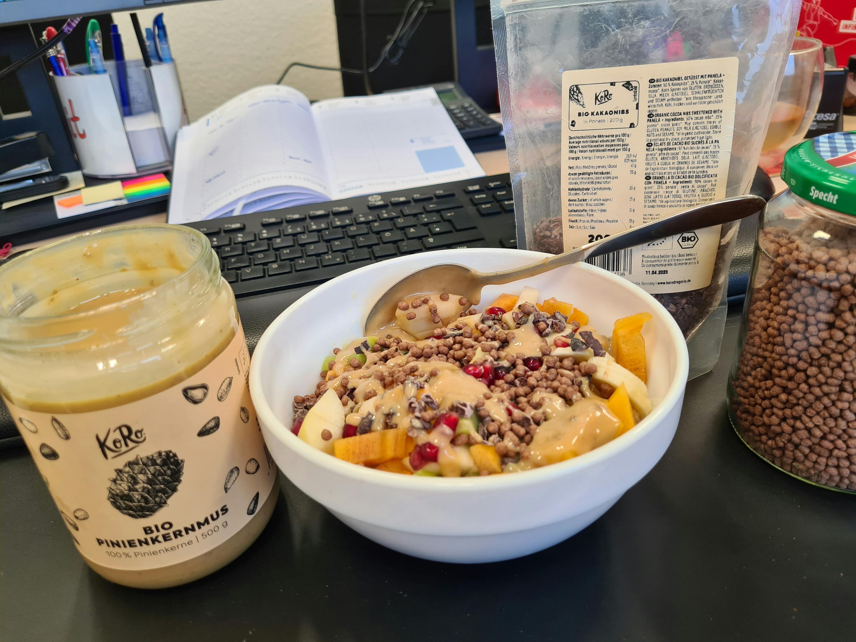 a jar of peanut butter sits next to a bowl of food