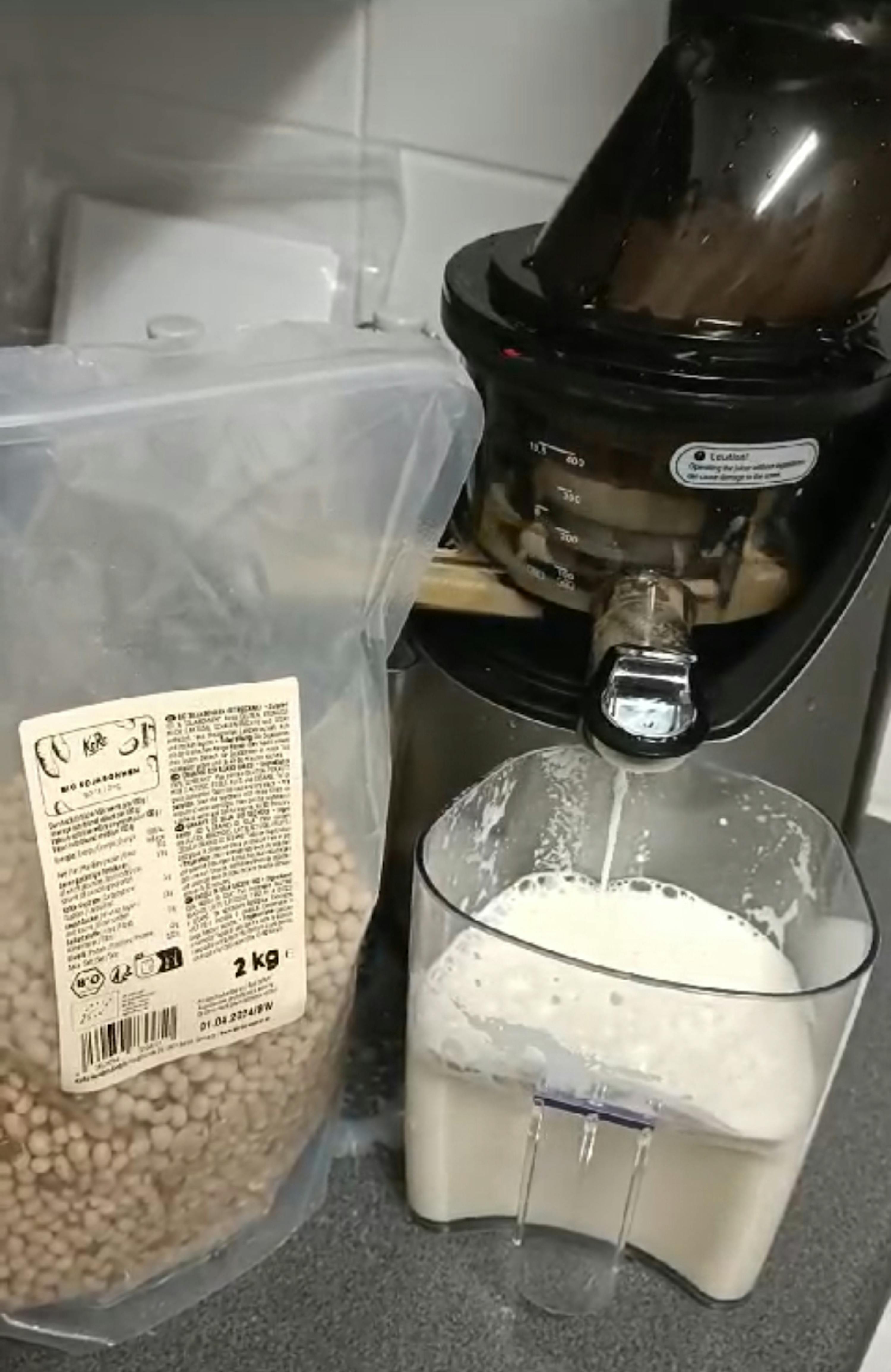 a bag of beans sits next to a blender
