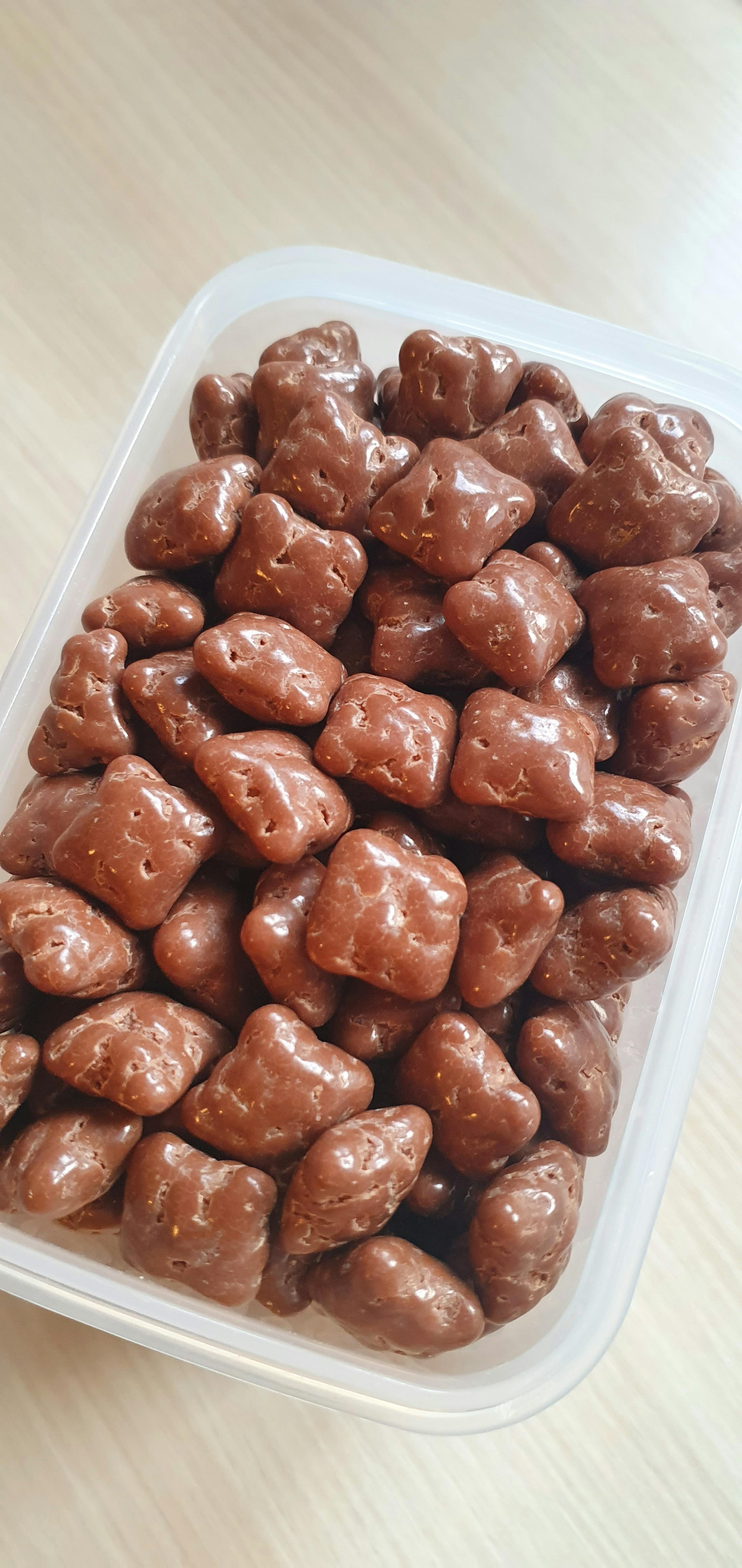 a plastic container filled with chocolate covered gummy bears