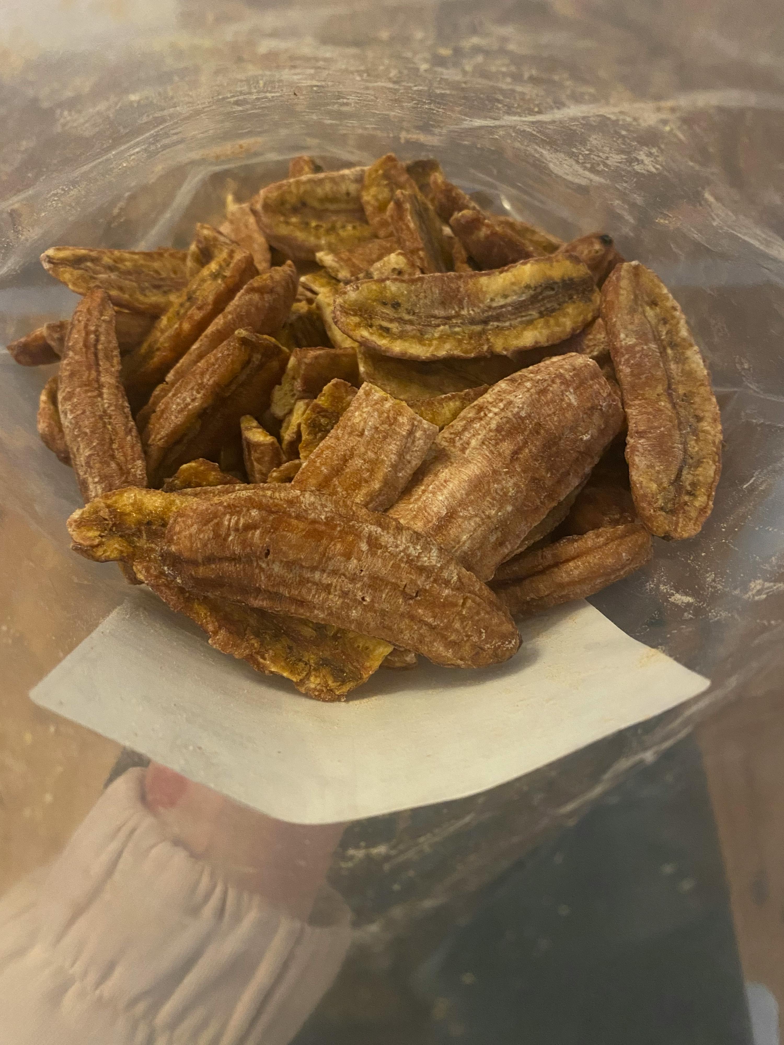 a bag of dried bananas sits on a piece of paper