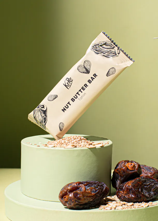 a nut butter bar with dates and oats on a podium