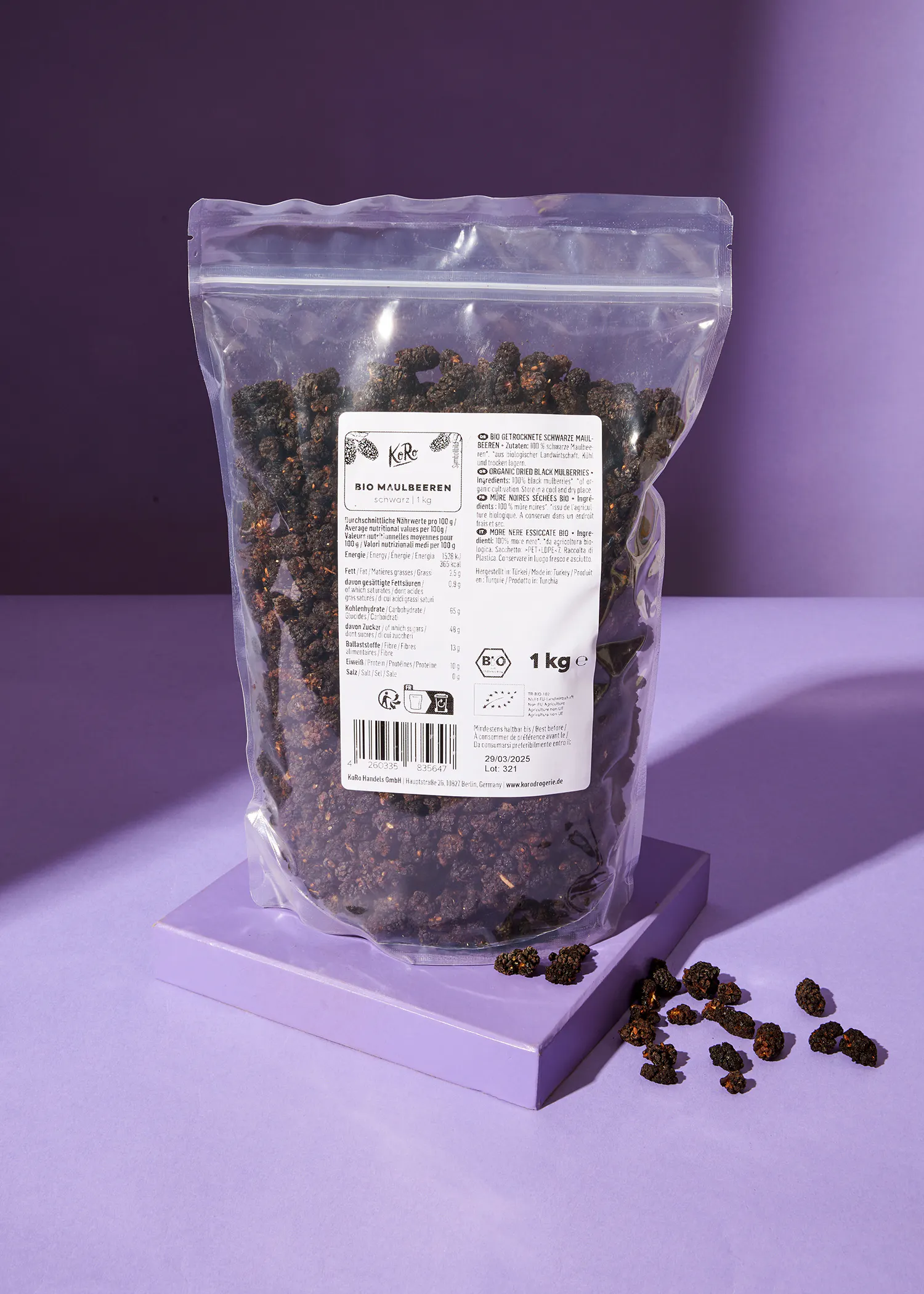 a bag of dried mulberries sits on a purple table